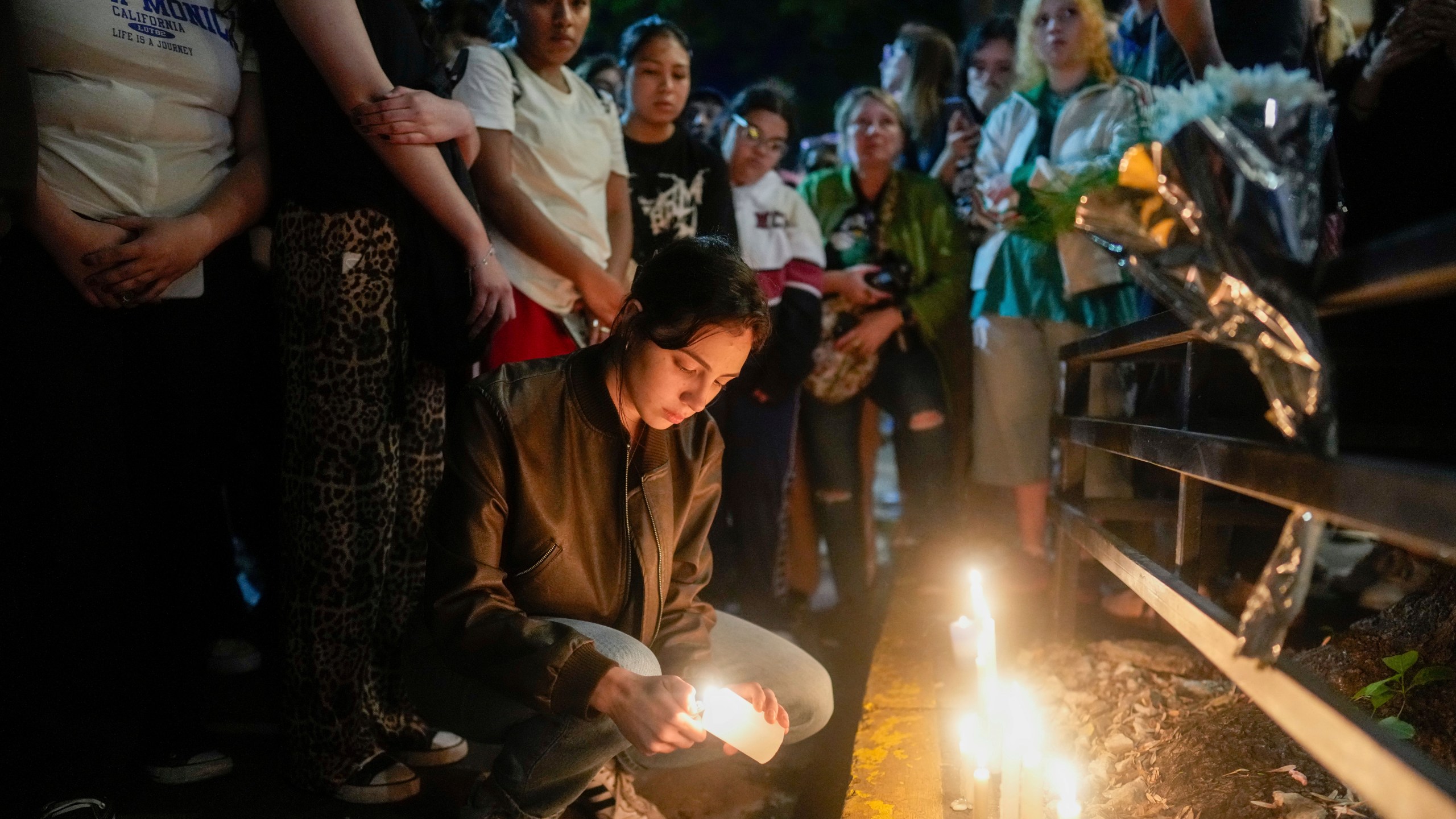 Fans light candles outside the hotel where former One Direction singer Liam Payne was found dead after he fell from a balcony in Buenos Aires, Argentina, Wednesday, Oct. 16, 2024. (AP Photo/Natacha Pisarenko)