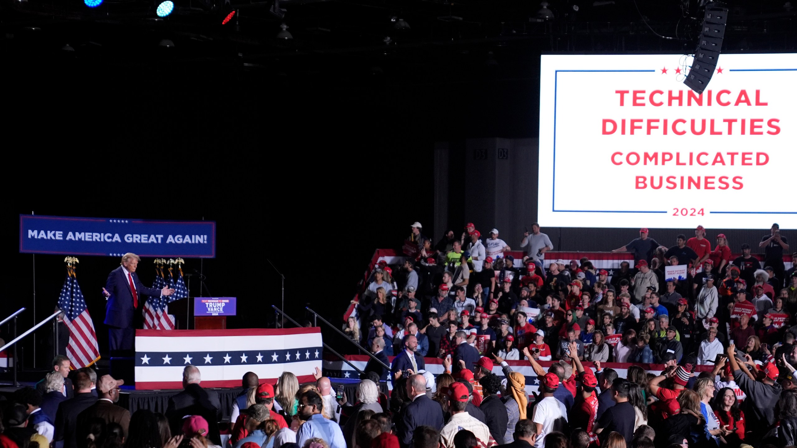 Republican presidential nominee former President Donald Trump pauses during technical difficulties at a campaign rally, Friday, Oct. 18, 2024, in Detroit. (AP Photo/Evan Vucci)