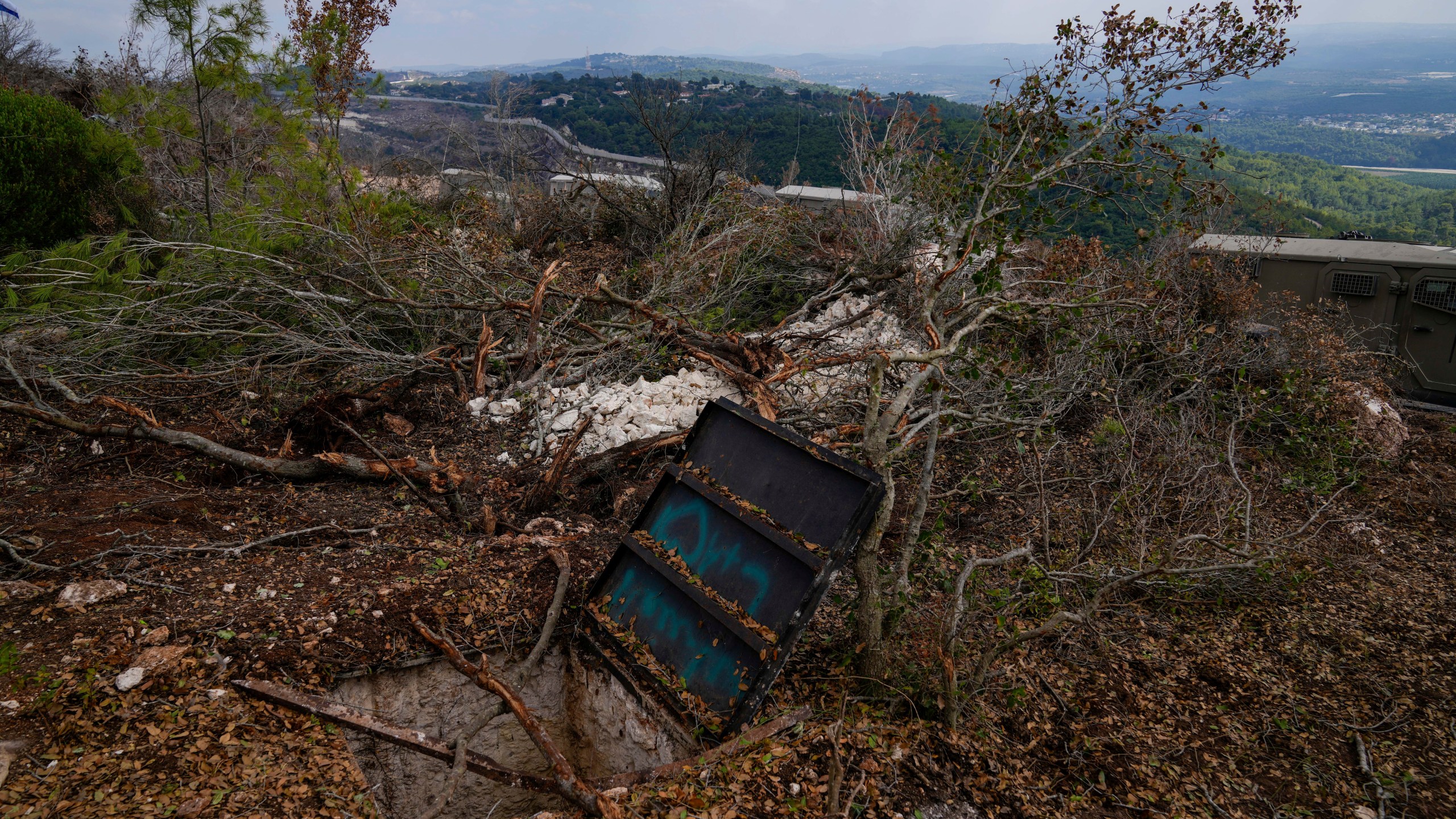 Israeli soldiers display what they say is an entrance to a Hezbollah tunnel found during their ground operation in southern Lebanon, near the border with Israel, Sunday, Oct. 13, 2024. (AP Photo/Sam McNeil)