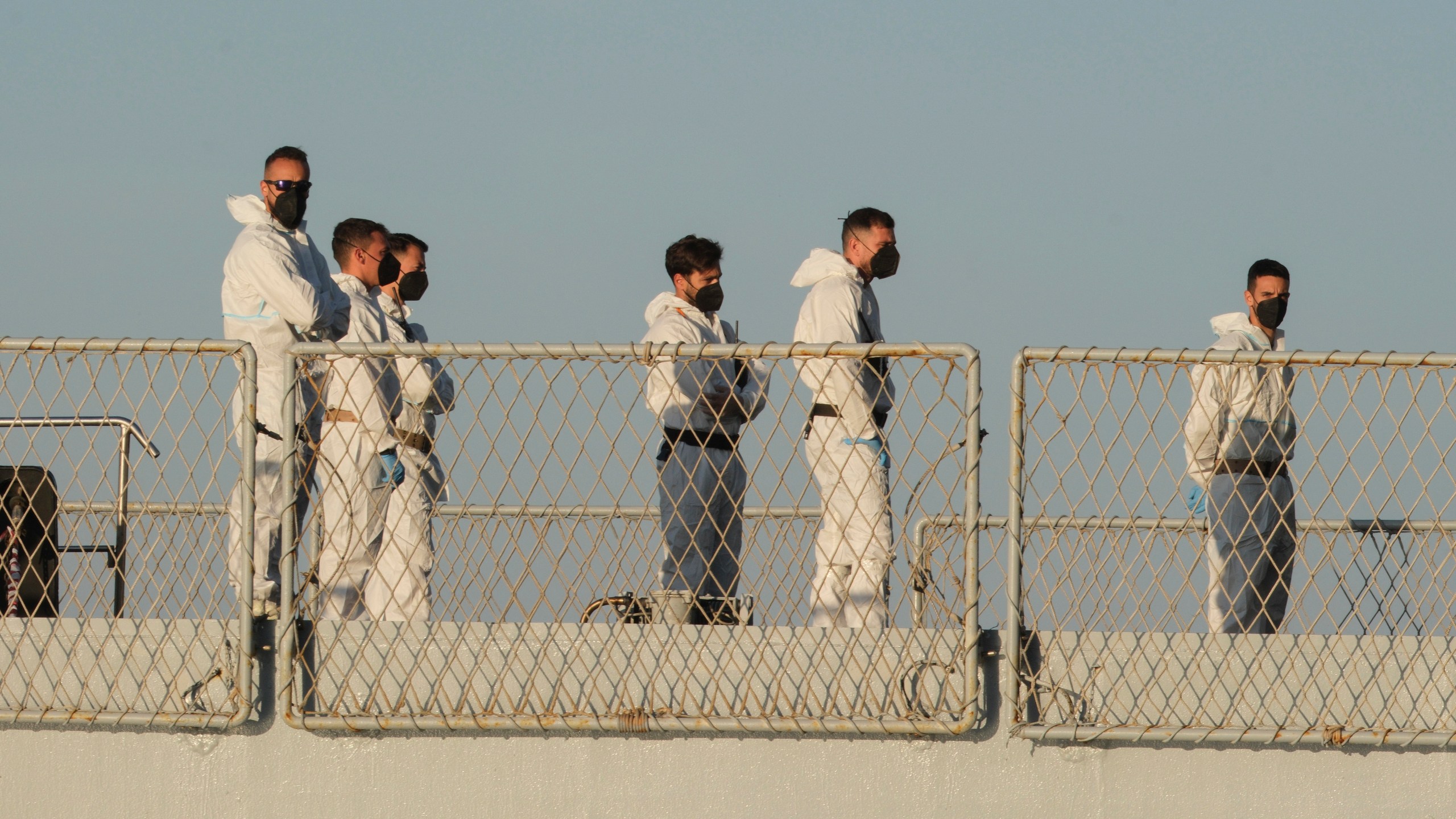 Security official stand on the Italian navy ship Libra as it arrives at the port of Shengjin, northwestern Albania Wednesday, Oct. 16, 2024, carrying the first group of migrants who were intercepted in international waters. (AP Photo/Vlasov Sulaj)