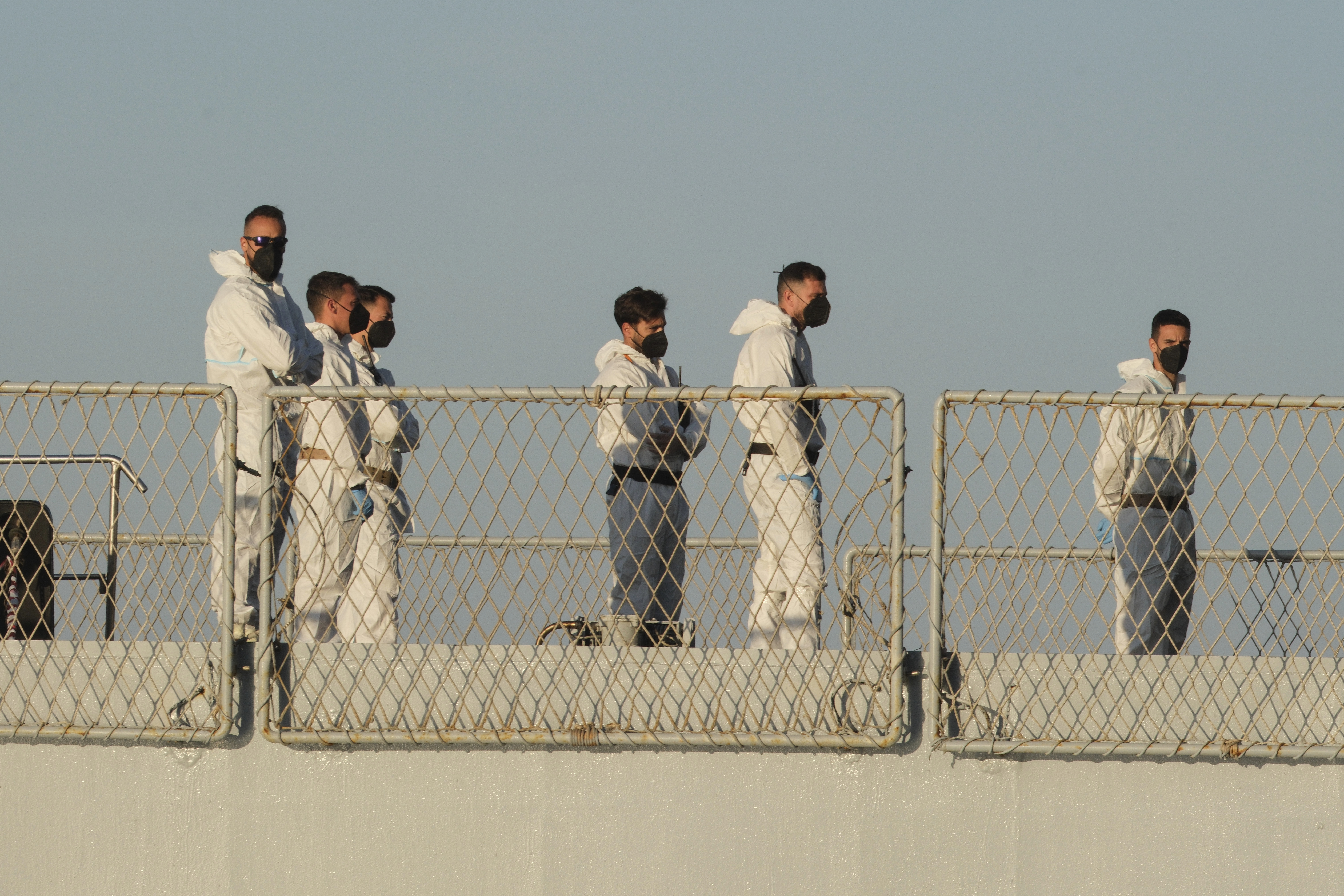 Security official stand on the Italian navy ship Libra as it arrives at the port of Shengjin, northwestern Albania Wednesday, Oct. 16, 2024, carrying the first group of migrants who were intercepted in international waters. (AP Photo/Vlasov Sulaj)