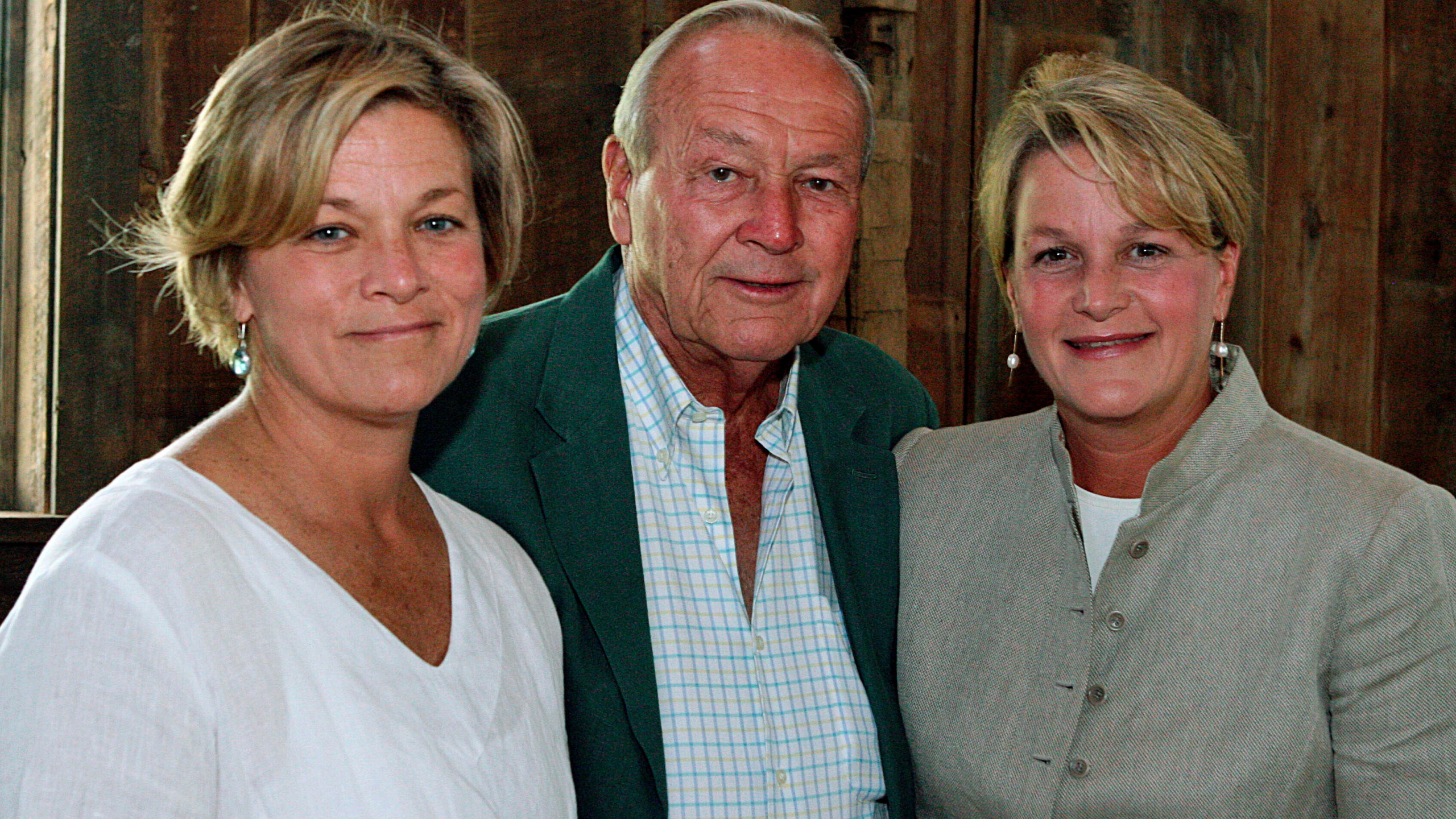 FILE - Arnold Palmer, center, is seen with his daughters, Peggy Palmer, left, of Durham, N.C., and Amy Saunders, of Orlando, Fla., inside the barn of the Winnie Palmer Nature Reserve, in Latrobe, Pa., during the dedication of the reserve June, 30, 2007. ( Kim Stepinsky/Pittsburgh Tribune-Review via AP, File)