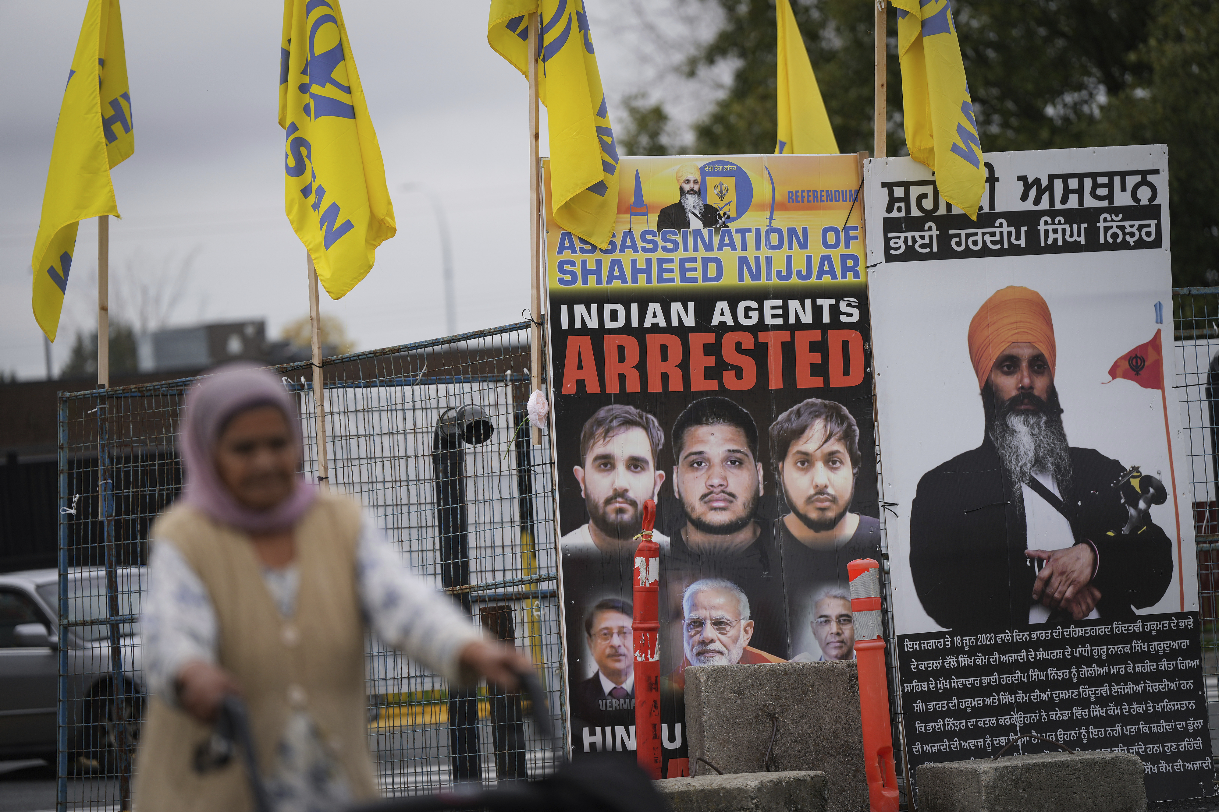 A photograph of late temple president Hardeep Singh Nijjar, back right, is displayed outside the Guru Nanak Sikh Gurdwara Sahib, in Surrey, British Columbia, Tuesday, Oct. 15, 2024. (Darryl Dyck/The Canadian Press via AP)