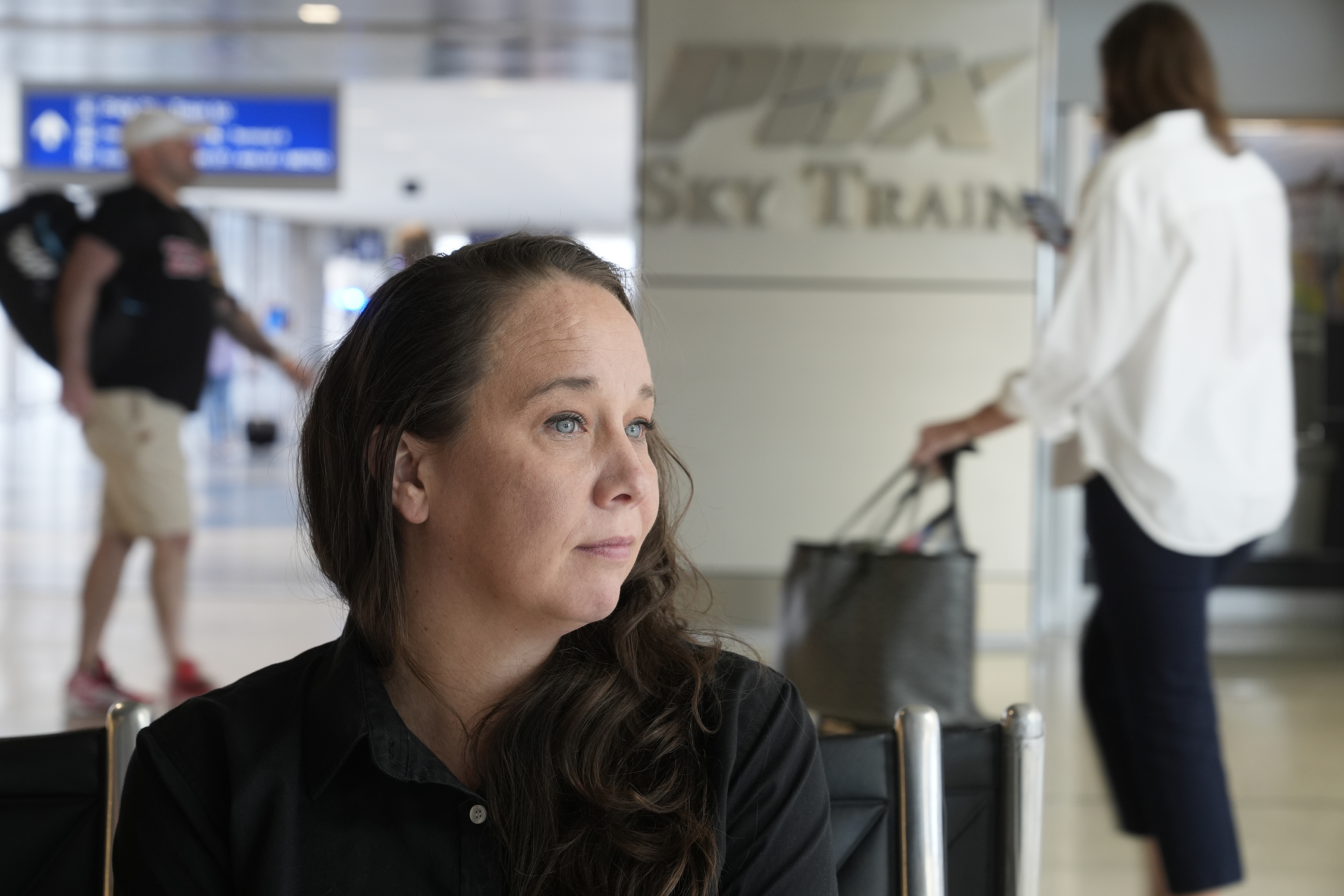 Lindsay Ruck, a server at Phoenix Sky Harbor International Airport restaurants, pauses in Terminal 3 as she works for minimum wage plus tips and is interested in the upcoming election and the Arizona Prop 138 on minimum wage vote Thursday, Oct. 3, 2024, in Phoenix. (AP Photo/Ross D. Franklin)