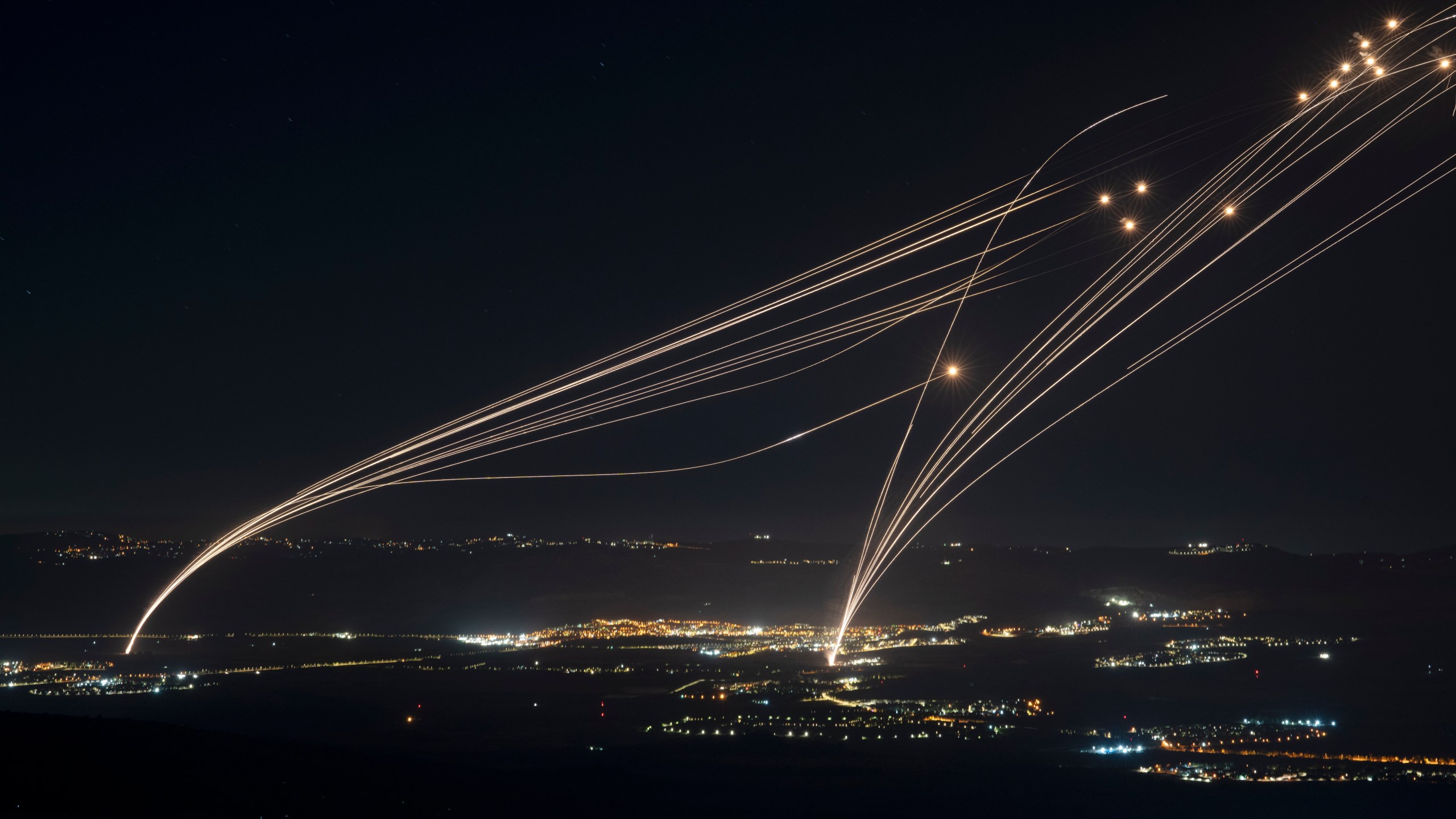 FILE - The Israeli Iron Dome air defense system fires to intercept an attack from Lebanon over the Galilee region as seen from the Israeli-annexed Golan Heights, on Aug. 4, 2024. (AP Photo/Leo Correa, File)