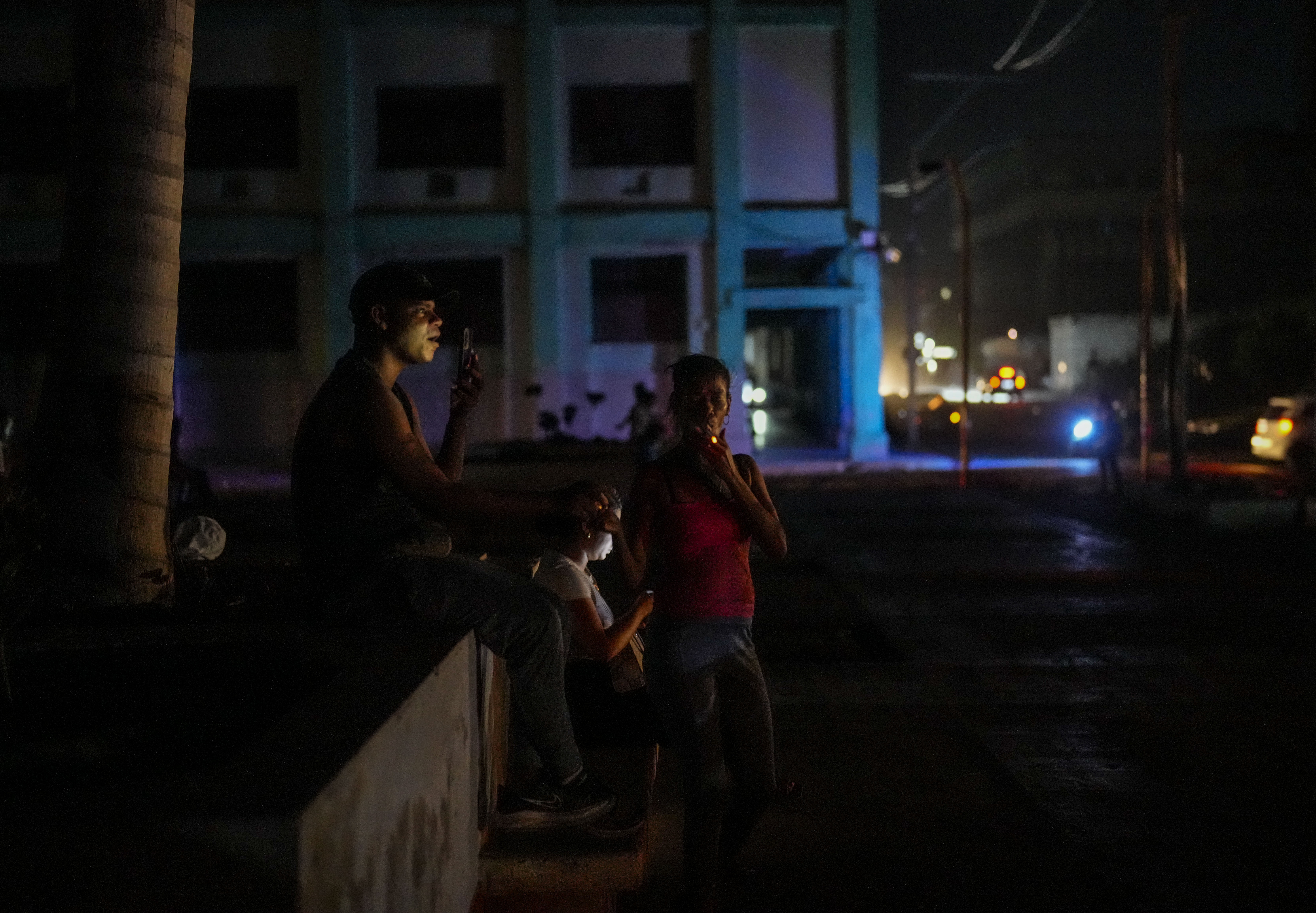 Residents pass the time during a blackout following the failure of a major power plant in Havana, Cuba, Sunday, Oct. 20, 2024. (AP Photo/Ramon Espinosa)