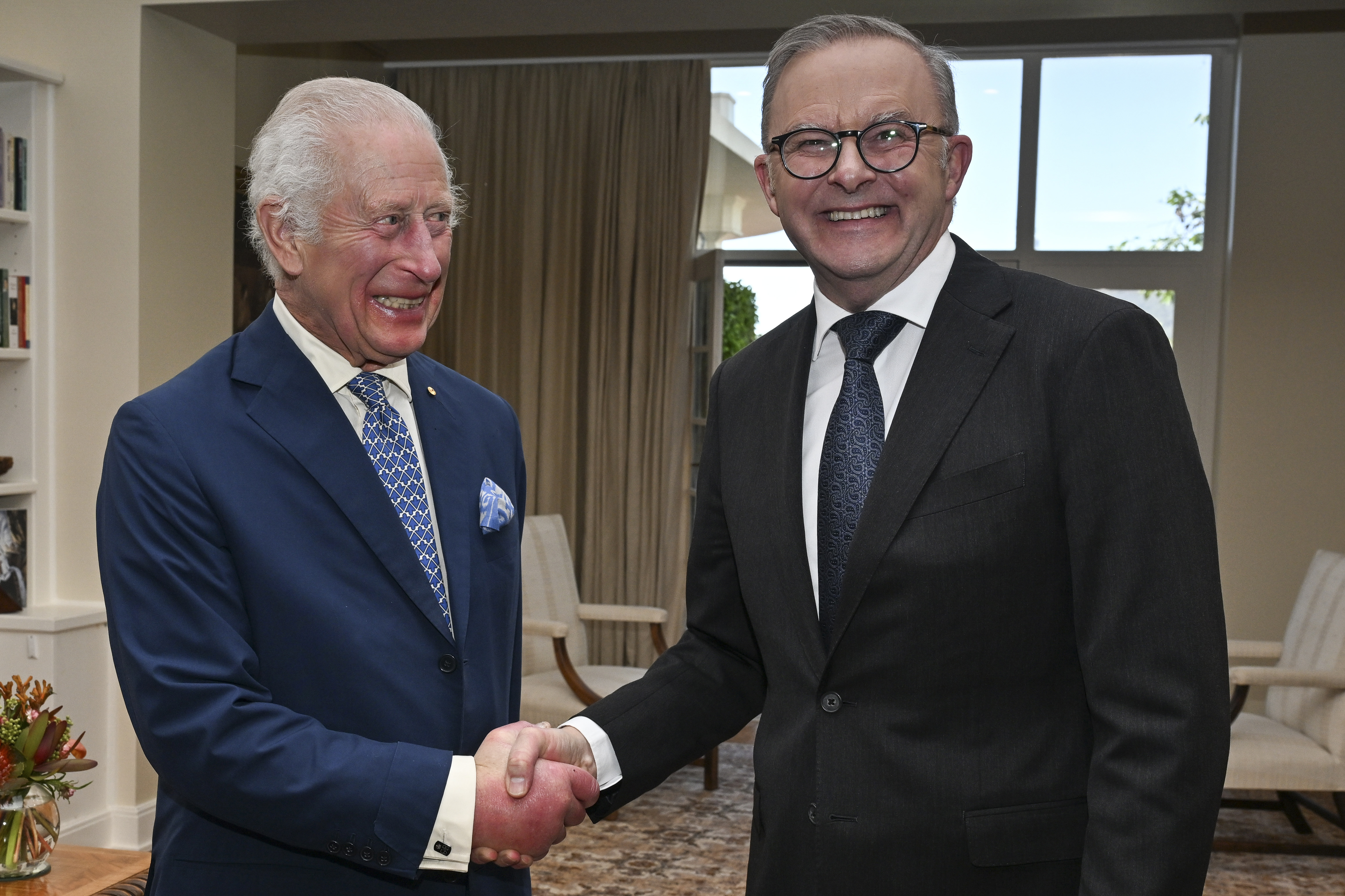 Britain's King Charles III shakes hands with Australia's Prime Minister Anthony Albanese, right, at Government House in Canberra, Australia, Monday, Oct. 21, 2024. (Saeed Khan/Pool Photo via AP)