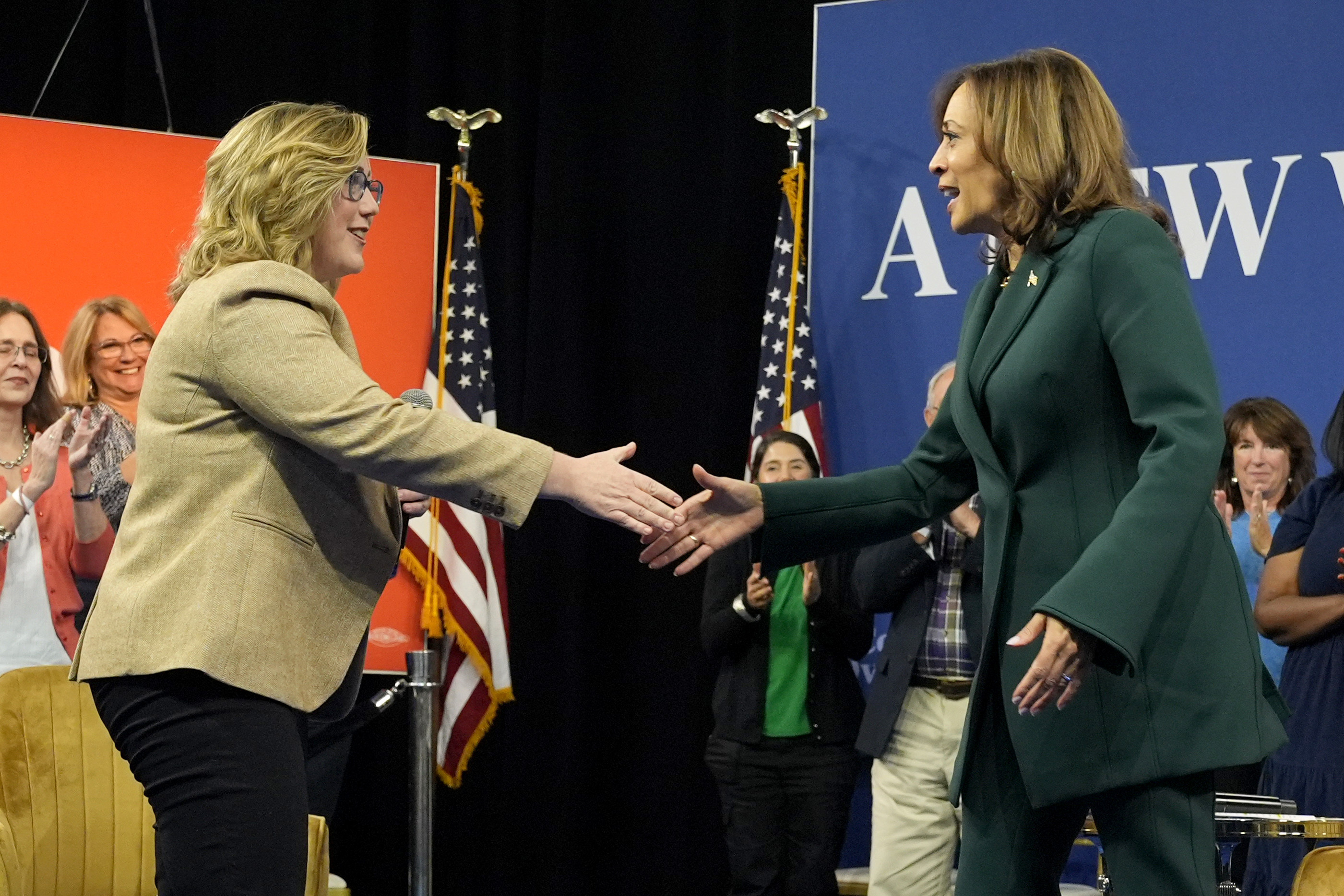 Democratic presidential nominee Vice President Kamala Harris, right, shakes hands with moderator Sarah Longwell, publisher of The Bulwark, at the conclusion of a town hall at The People's Light in Malvern, Pa., Monday, Oct. 21, 2024. (AP Photo/Jacquelyn Martin)