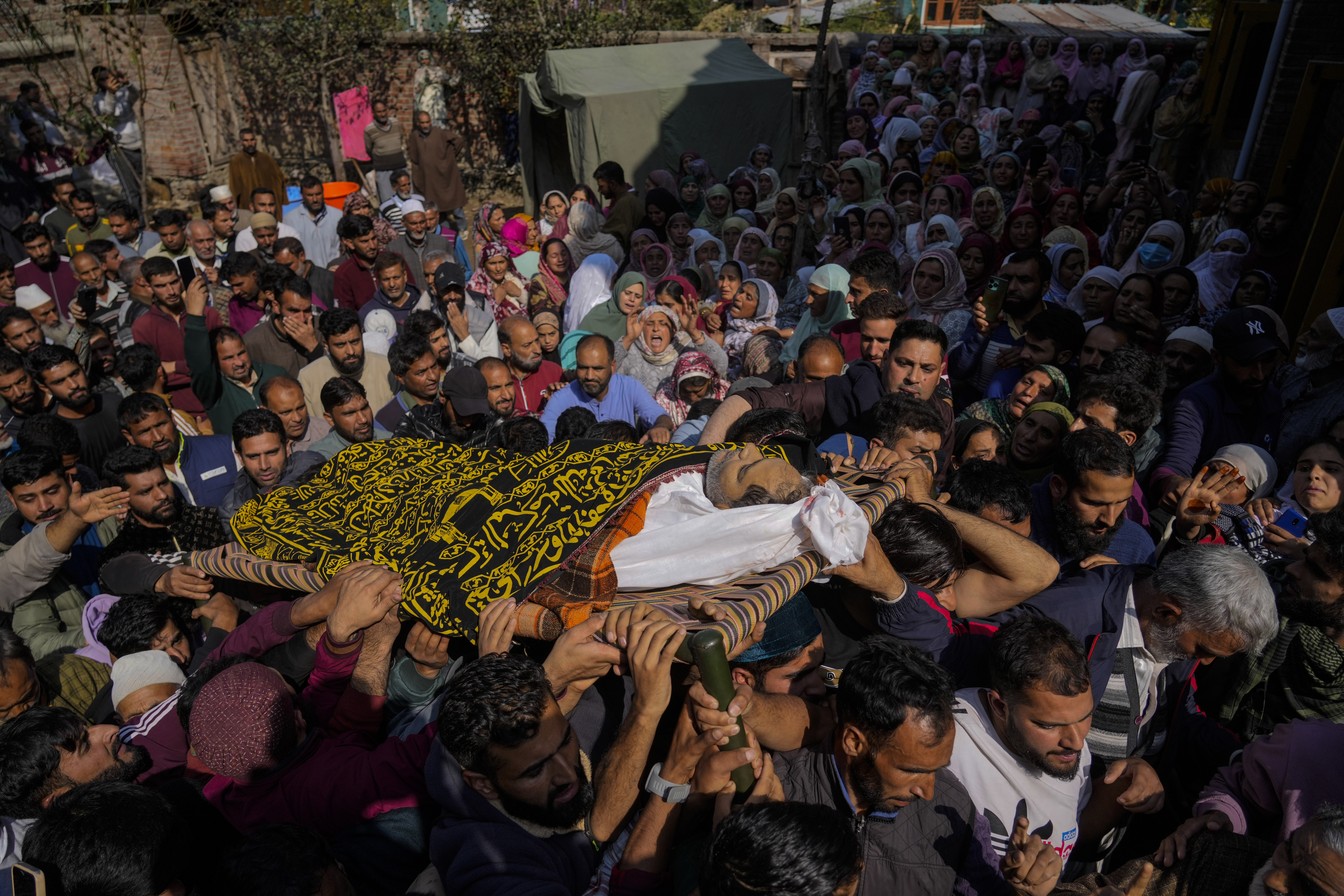 Villagers carry the body of Kashmiri doctor Shahnawaz who was among those killed when gunmen fired at people working on a strategic tunnel project in Indian-controlled Kashmir, during his funeral at Nadigam village, southwest of Srinagar, Monday, Oct. 21, 2024. (AP Photo/Mukhtar Khan)