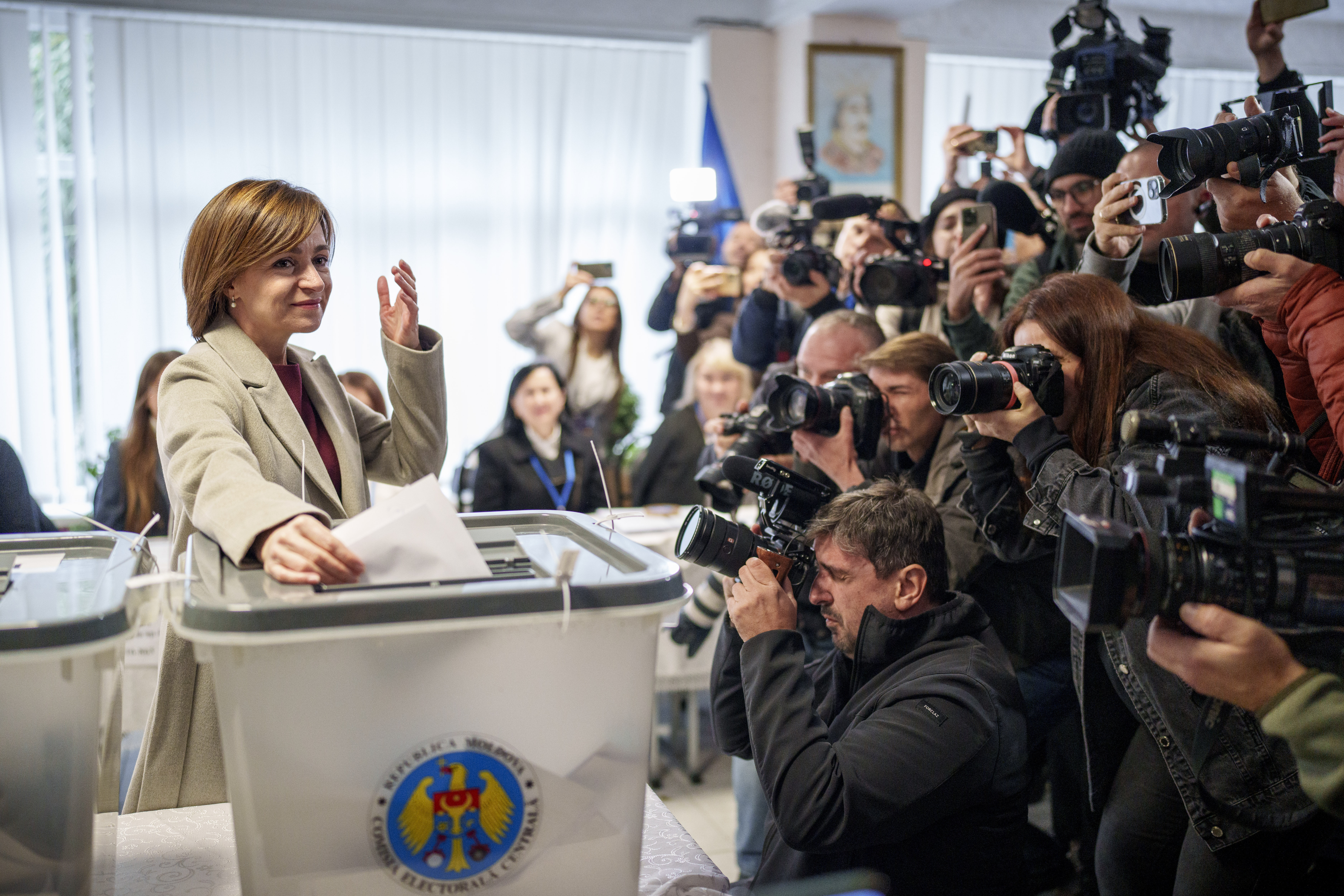 Moldova's President Maia Sandu prepares to cast her vote, in Chisinau, Moldova, Sunday, Oct. 20, 2024, during a presidential election and a referendum on whether to enshrine in the Constitution the country's path to European Union membership. (AP Photo/Vadim Ghirda)