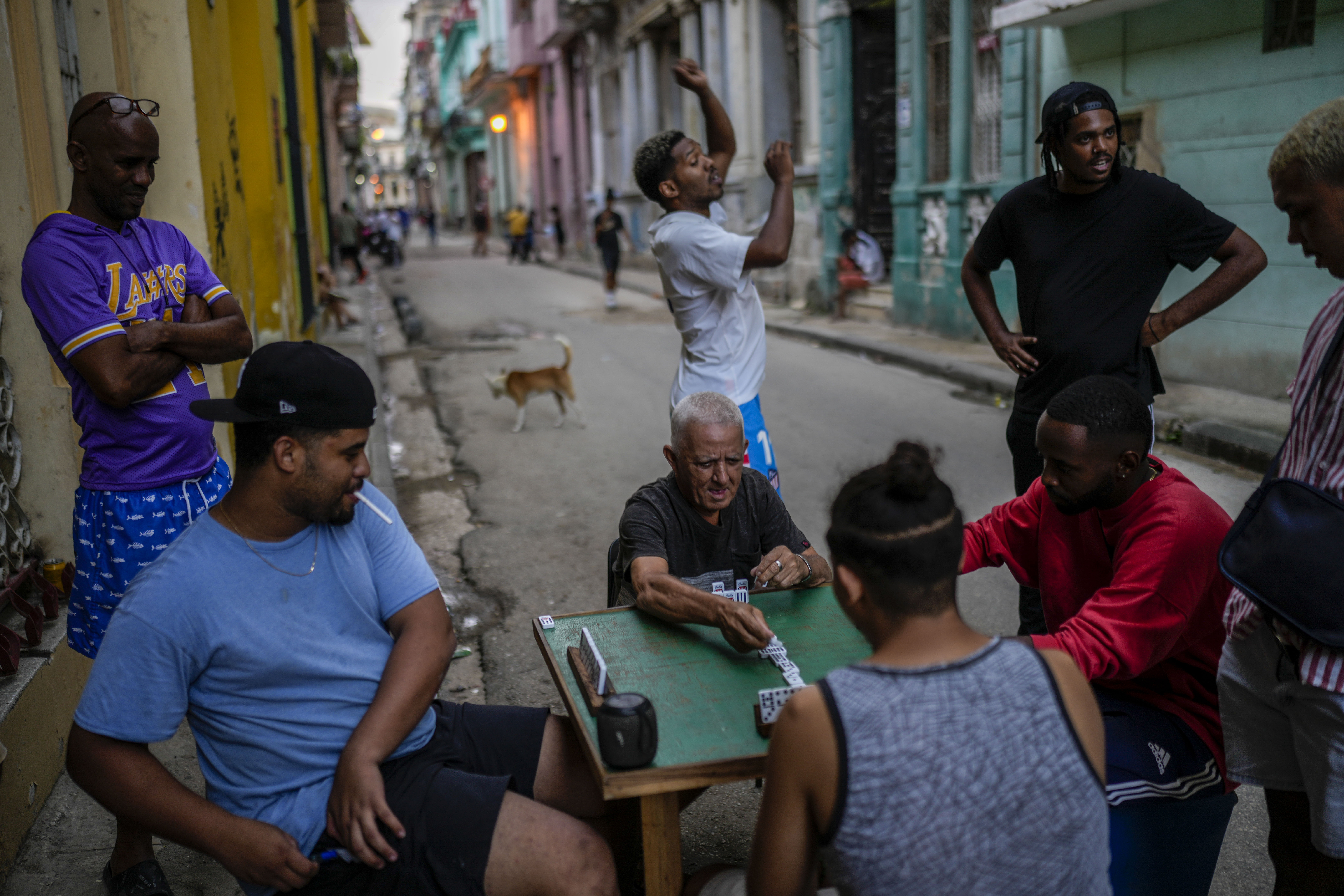 People play dominoes on the street during a power outage in Havana, Cuba, Monday, Oct. 21, 2024. (AP Photo/Ramon Espinosa)