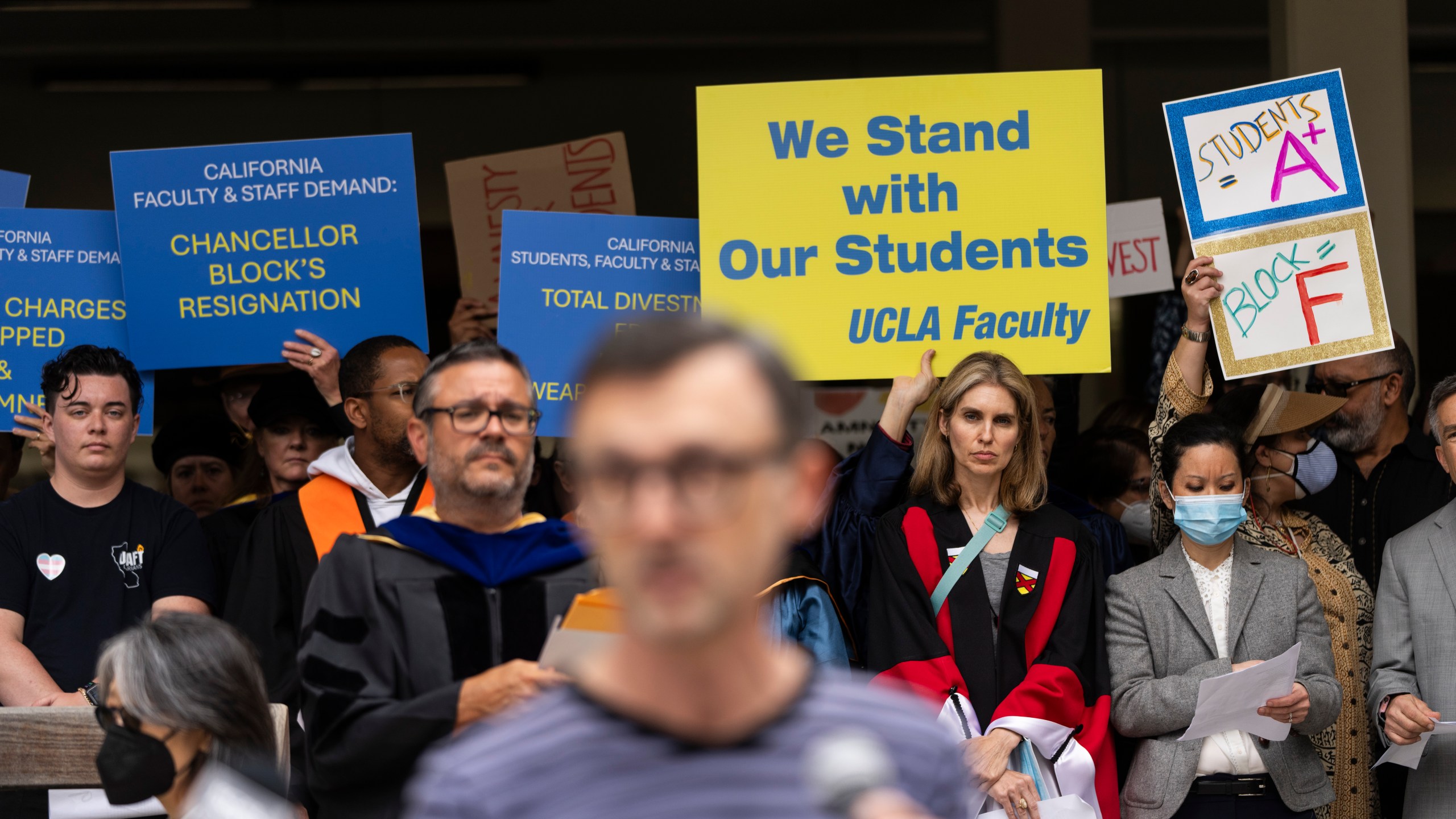 FILE - UCLA faculty and staff members hold up signs during a news conference at UCLA in Los Angeles, Thursday, May 9, 2024. (AP Photo/Jae C. Hong, File)