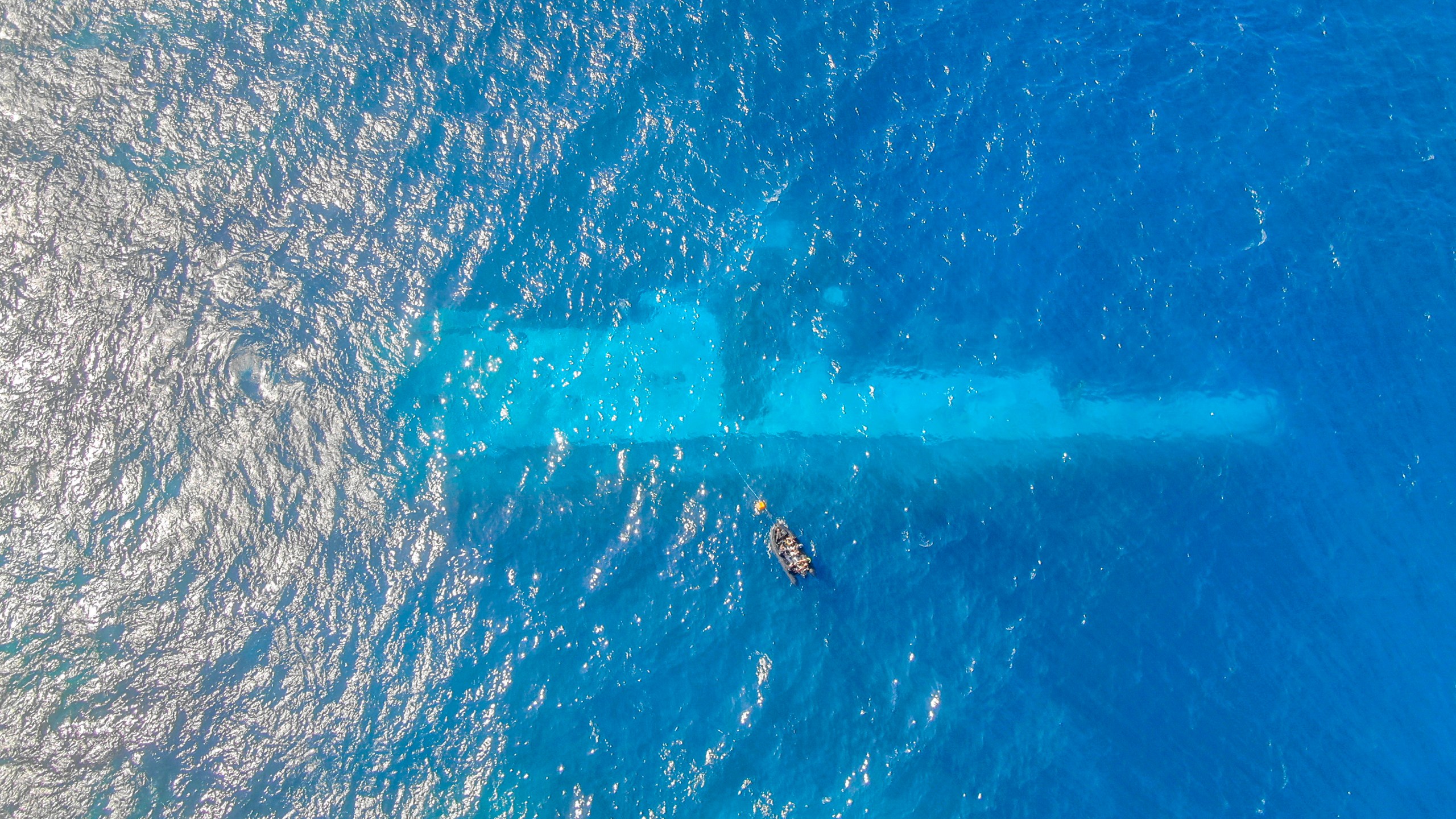 In this photo provided by the New Zealand Defence Force, divers survey the area around HMNZS Manawanui on the southern coast of Upulo, Samoa, after the Manawanui ran aground and sank on Oct. 6. (AC Jese Somerville/New Zealand Defence Force via AP)