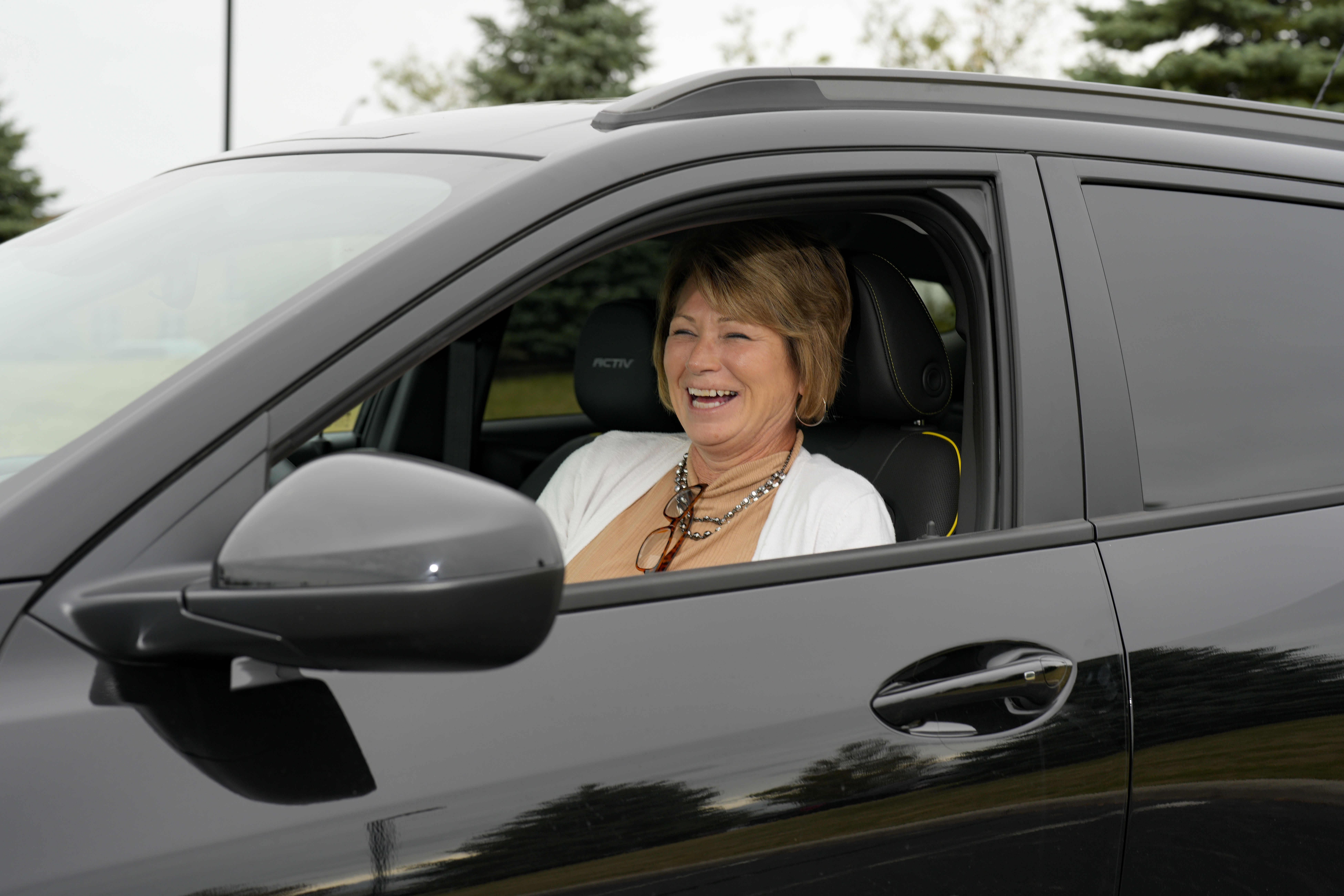 Michelle Chumley sits in her new Chevrolet Trax compact SUV, Thursday, Sept. 26, 2024, in West Chester, Ohio. (AP Photo/Jeff Dean)