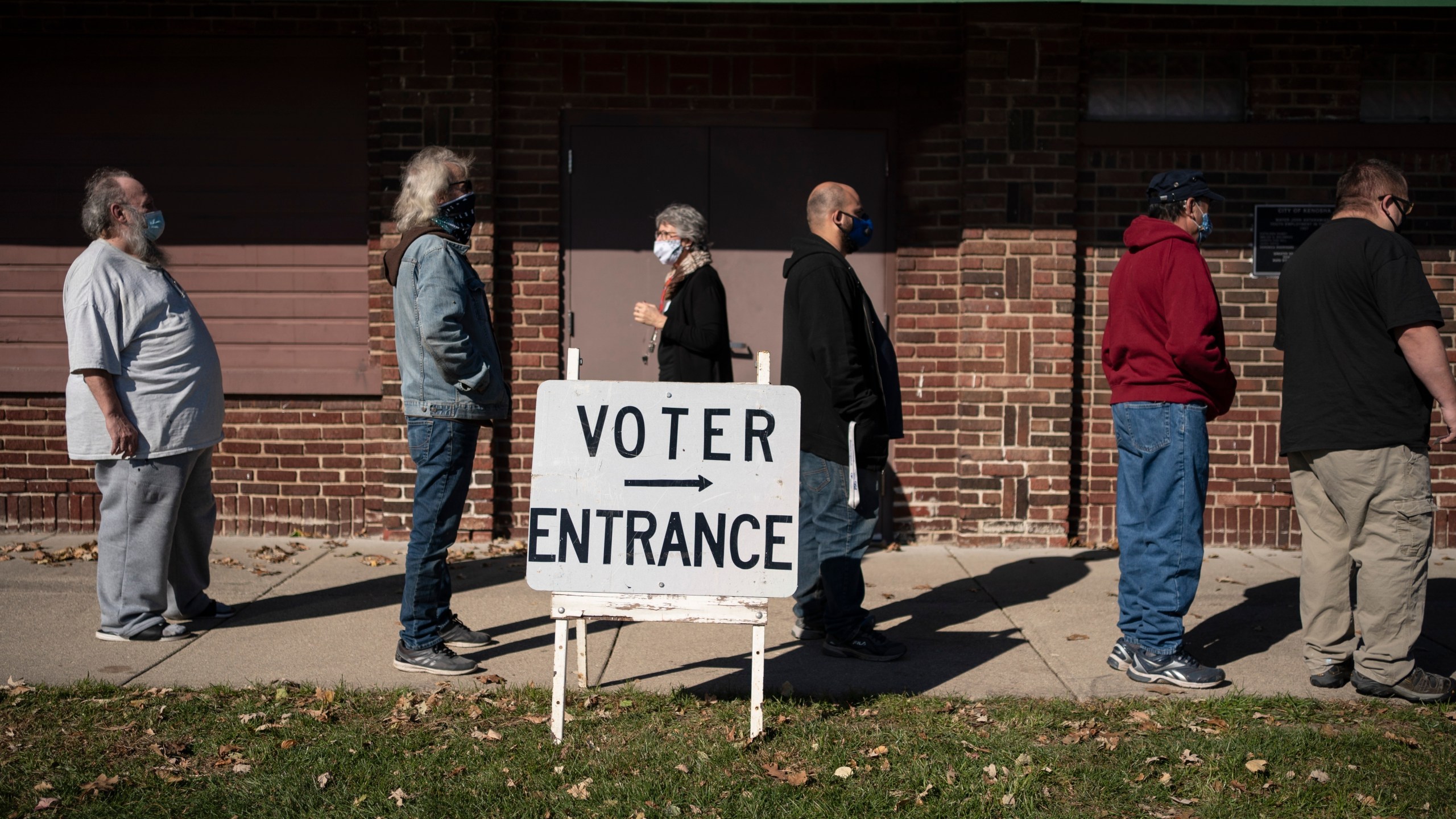 FILE - In this Tuesday, Nov. 3, 2020, file photo, voters wait in line outside a polling center on Election Day, in Kenosha, Wis. (AP Photo/Wong Maye-E, File)