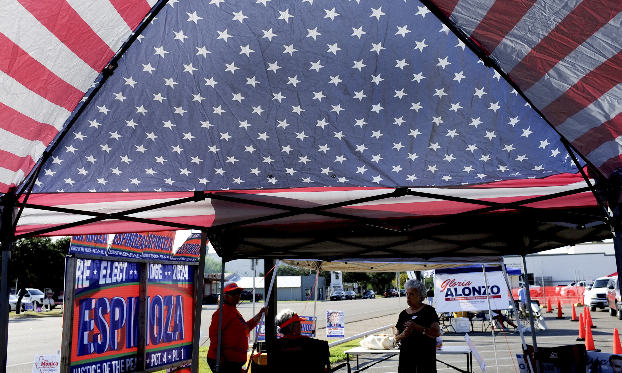 FILE - Local candidates are seen under a patriotic canopy during early voting at the Hidalgo County Annex, Oct. 21, 2024, in Edinburg, Texas. (Delcia Lopez/The Monitor via AP, File)