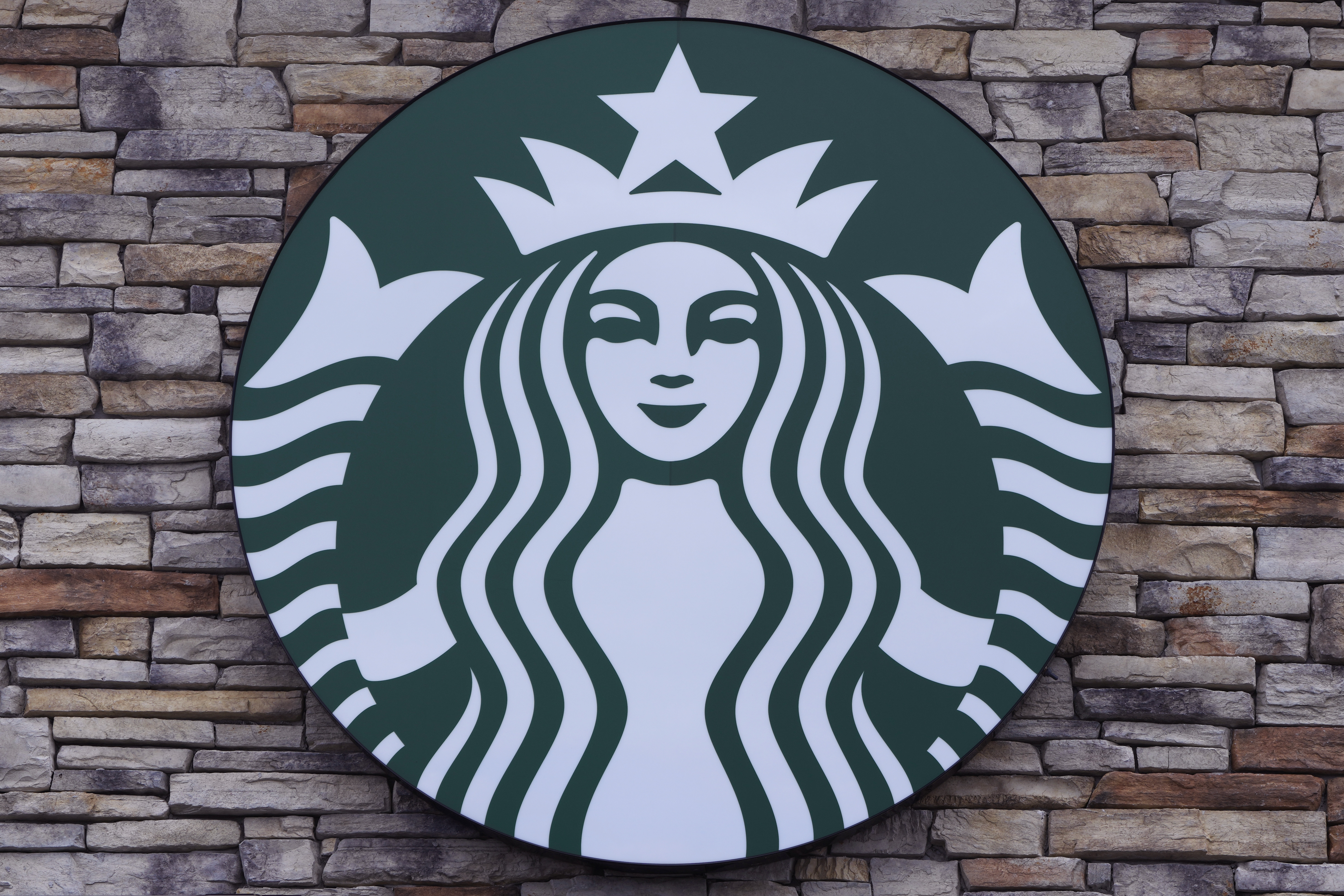 FILE - A Starbucks mermaid logo sign is displayed on a store, May 29, 2024, in Salem, N.H. (AP Photo/Charles Krupa, File)