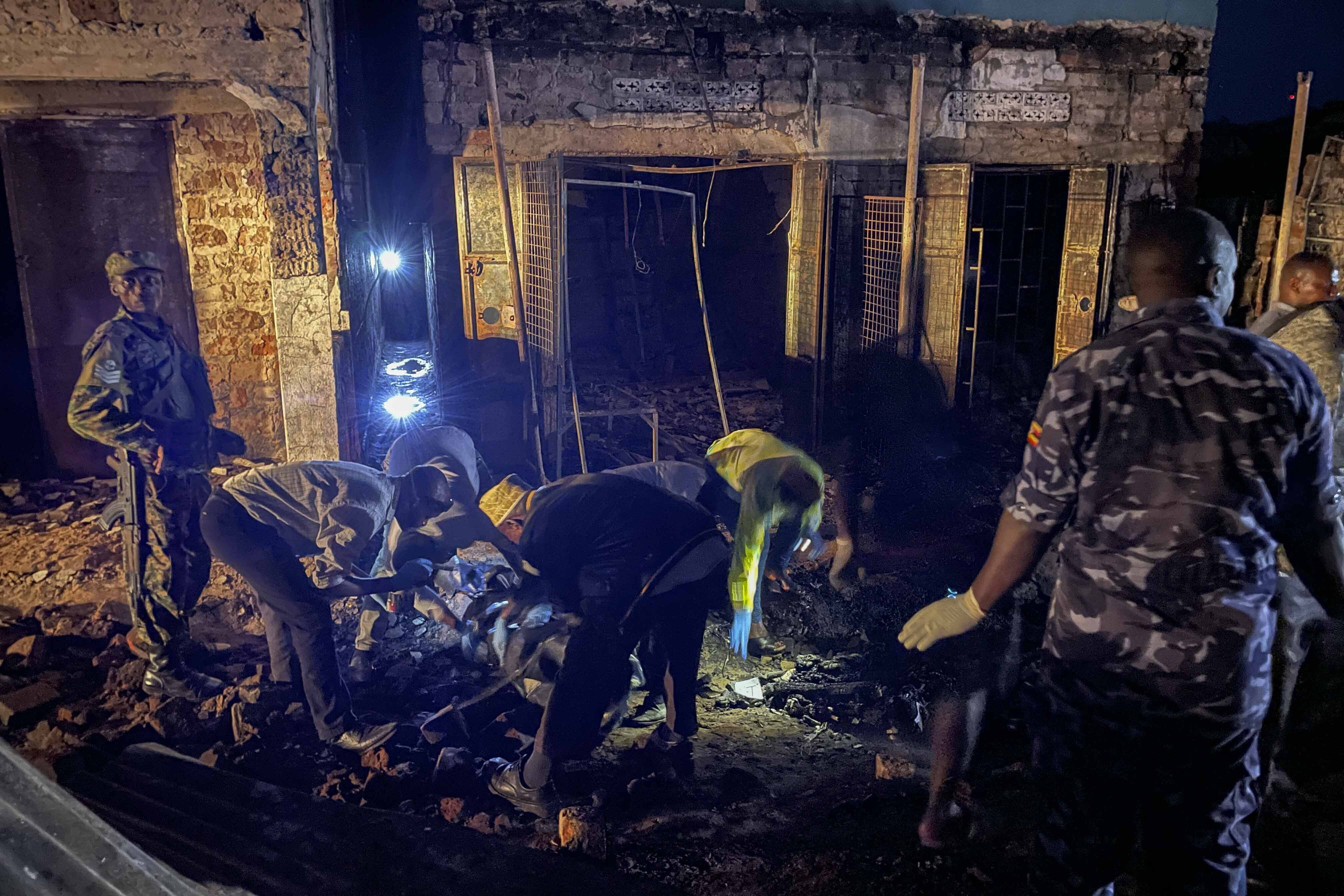 Uganda forensic officials inspect the site where a fuel truck exploded, on the outskirts of Kampala, Uganda, Tuesday, Oct. 22, 2024. (AP Photo)