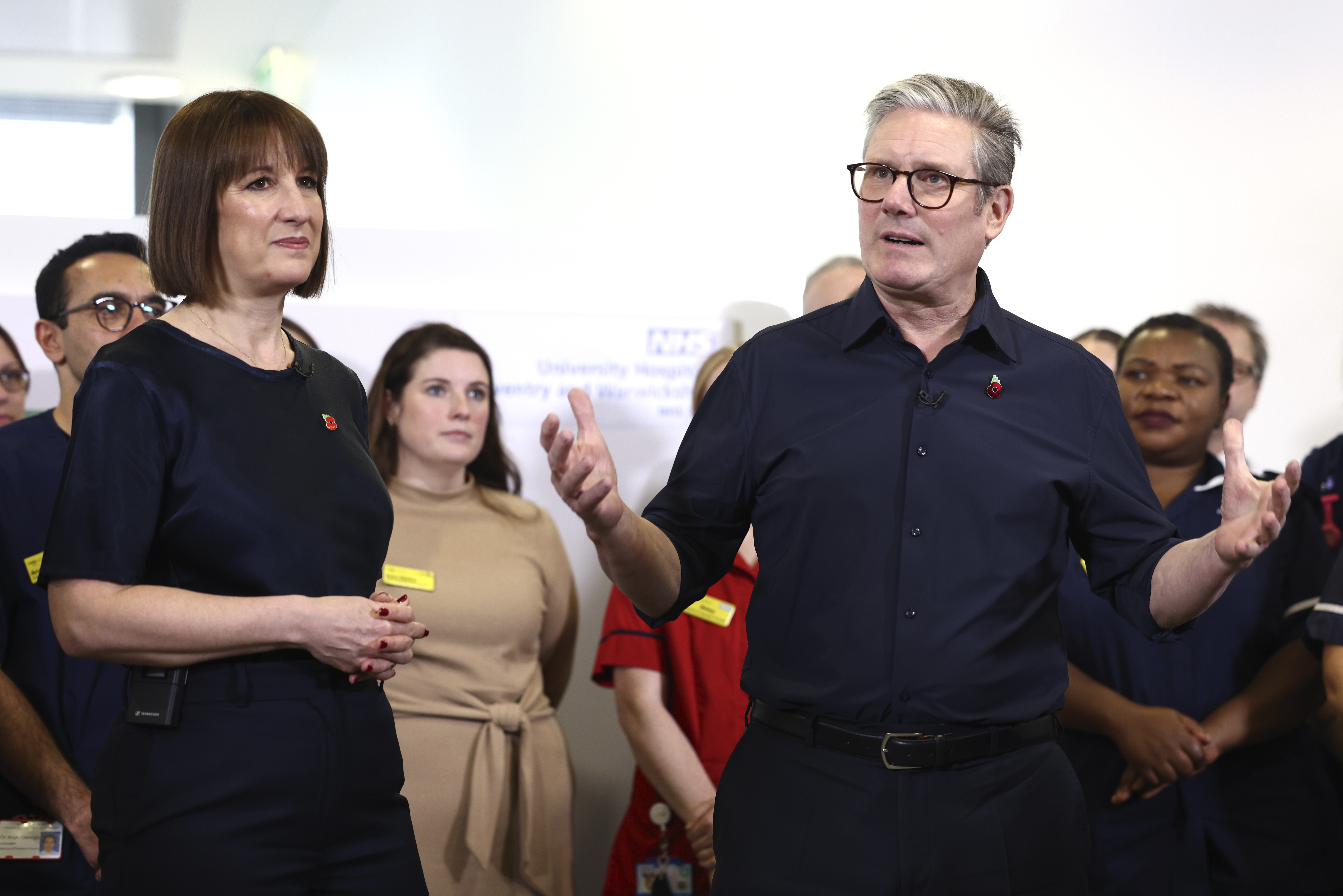 Britain's Prime Minister Keir Starmer and Chancellor Rachel Reeves speak with members of staff, during a visit to University Hospital Coventry and Warwickshire, in Coventry, England, Thursday, Oct. 31, 2024. (AP Photo/Darren Staples, pool)