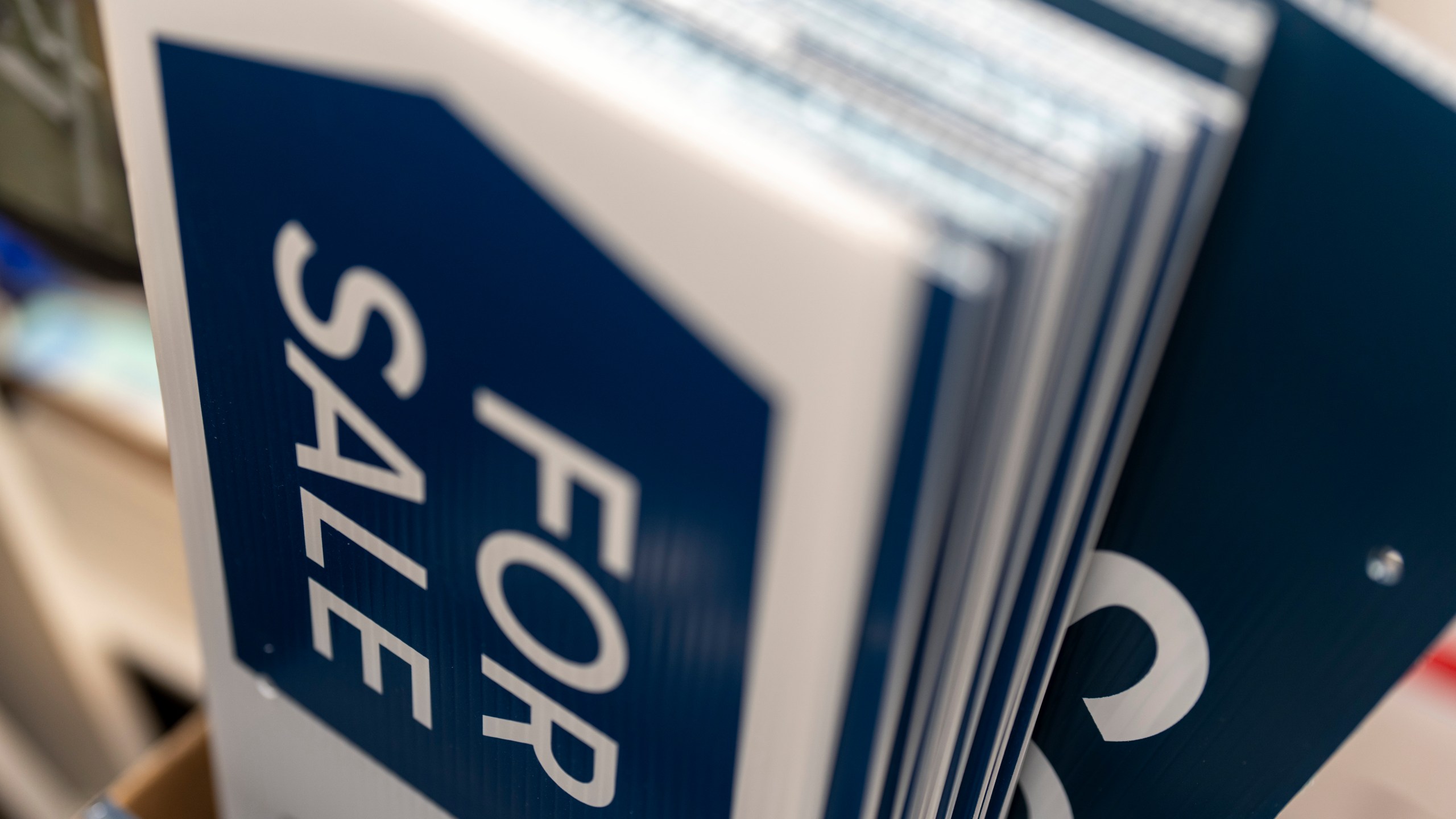 For sale and sold signs are seen in storage at a real estate office on Tuesday, Oct. 15, 2024, in Portland, Ore. (AP Photo/Jenny Kane)