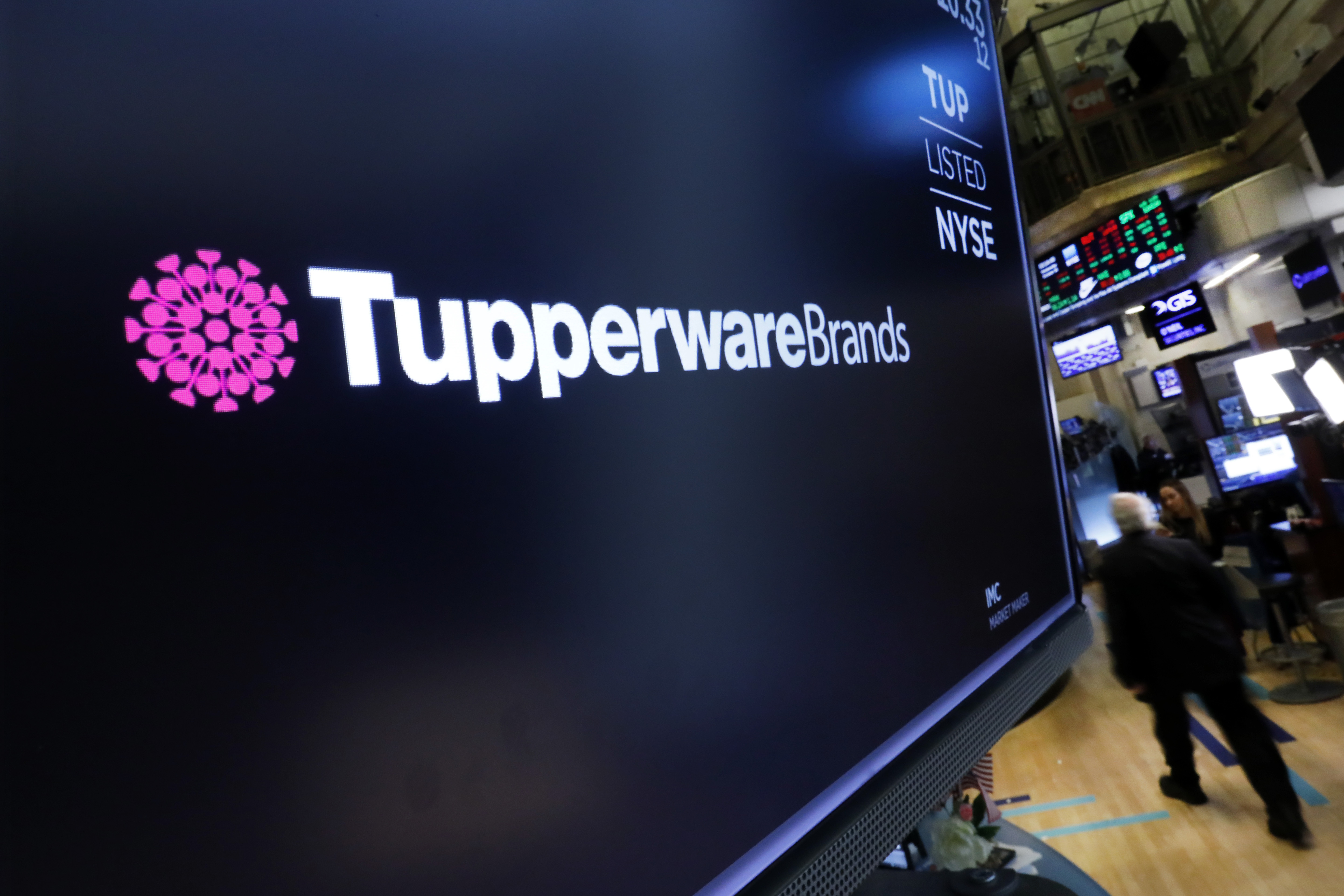 FILE - The logo for Tupperware Brands appears above a trading post on the floor of the New York Stock Exchange on Oct. 30, 2019. (AP Photo/Richard Drew)