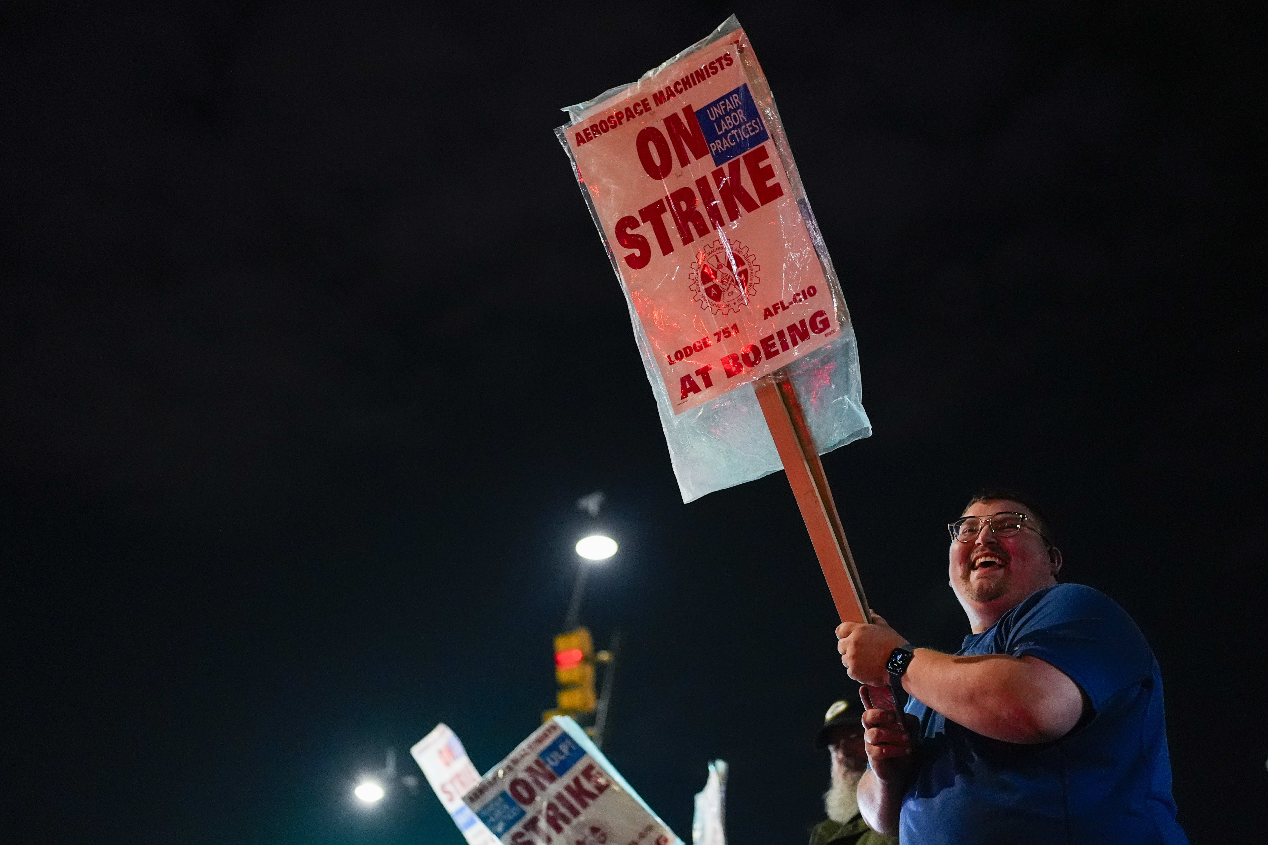 Machinist AJ Nelson, who has worked for Boeing for six years, works the picket line after union members voted to reject a new contract offer from the company, Wednesday, Oct. 23, 2024, in Renton, Wash. (AP Photo/Lindsey Wasson)