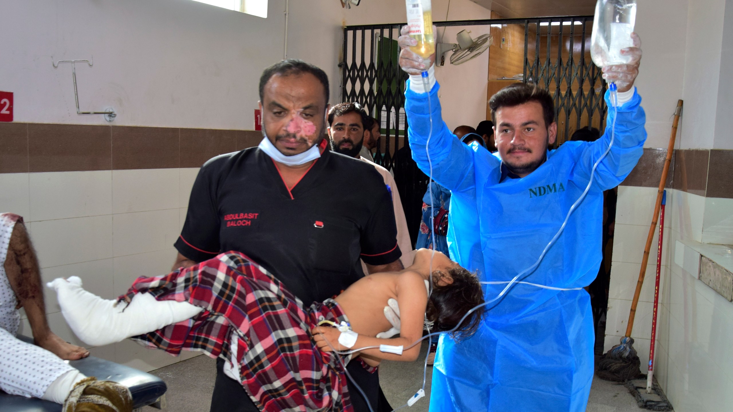 Paramedics carry a girl, who was injured in the bomb explosion in Mastung town, for treatment at a hospital in Quetta, Pakistan, Friday, Nov. 1, 2024. (AP Photo/Arshad Butt)