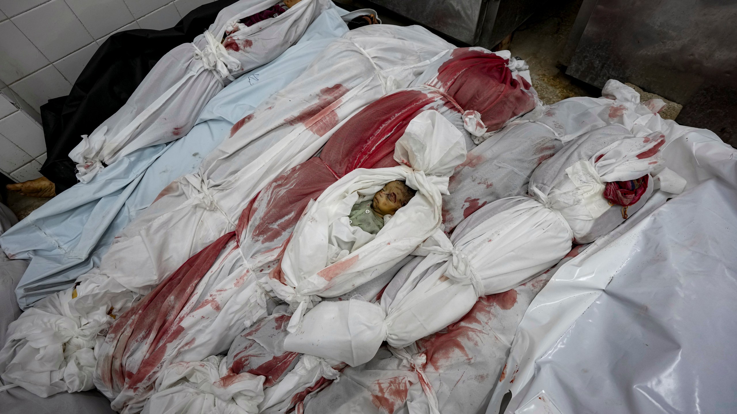 EDS NOTE: GRAPHIC CONTENT - Bodies of Palestinians killed in the Israeli bombardment of the Gaza Strip are seen at a hospital morgue in Deir al-Balah, Friday, Nov. 1, 2024. (AP Photo/Abdel Kareem Hana)