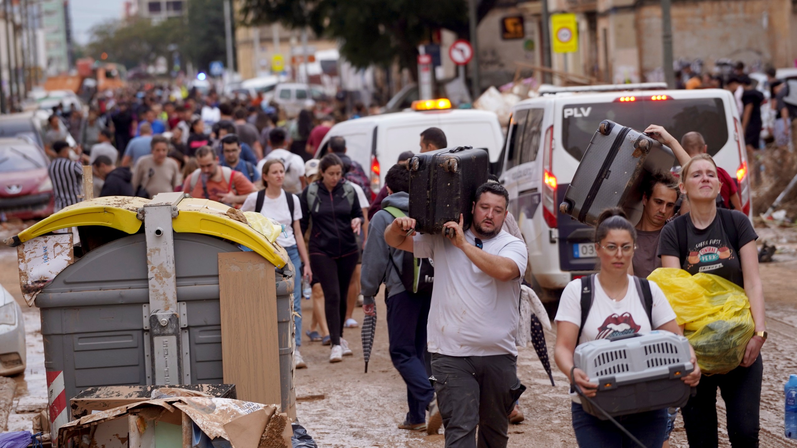 Residents carry their belongings as they leave their houses affected by floods in Valencia, Spain, Thursday, Oct. 31, 2024. (AP Photo/Alberto Saiz)