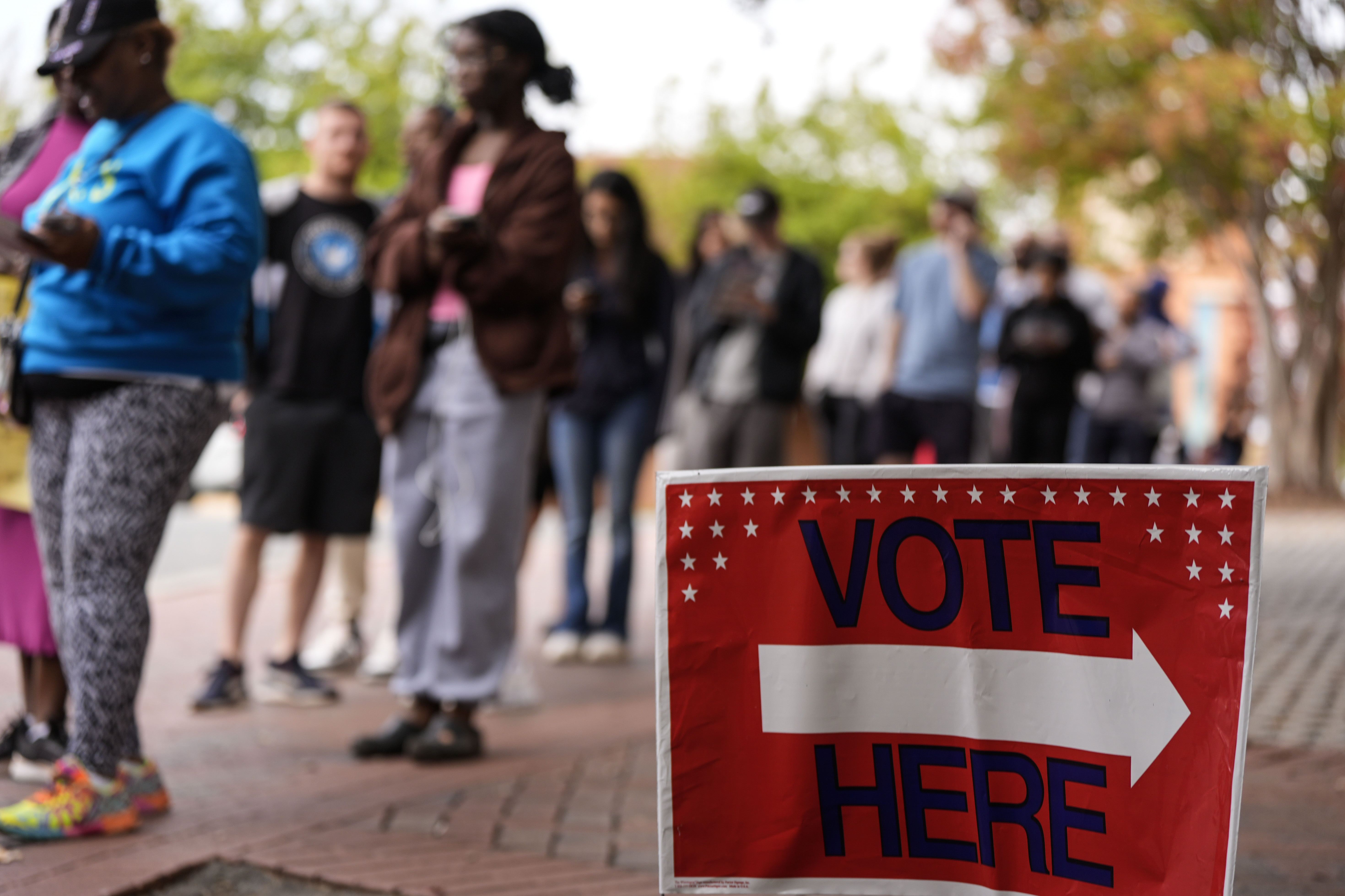 People stand in line during the last day of early voting, Saturday, Nov. 2, 2024, in Charlotte, N.C. (AP Photo/Mike Stewart)