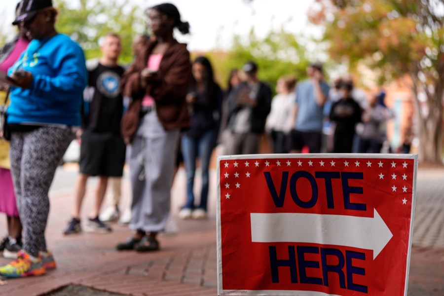 People stand in line during the last day of early voting, Saturday, Nov. 2, 2024, in Charlotte, N.C. (AP Photo/Mike Stewart)