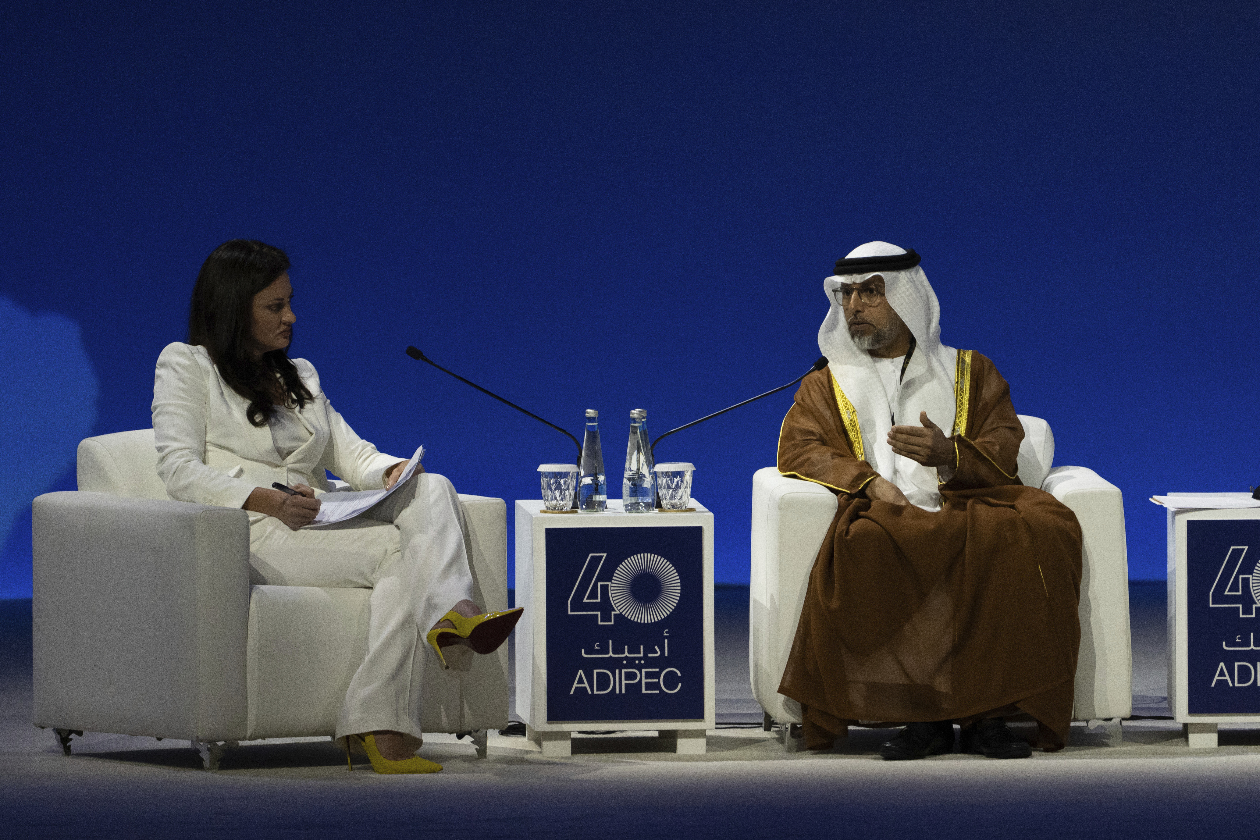 Moderator Hadley Gamble, left, looks on as UAE Minister of Energy and Infrastructure Suhail al-Mazrouei talks in a panel during the the inaugural session of annual Abu Dhabi International Petroleum Exhibition and Conference (ADIPEC) in Abu Dhabi, United Arab Emirates, Monday, Nov. 4, 2024. (AP Photo/Altaf Qadri)