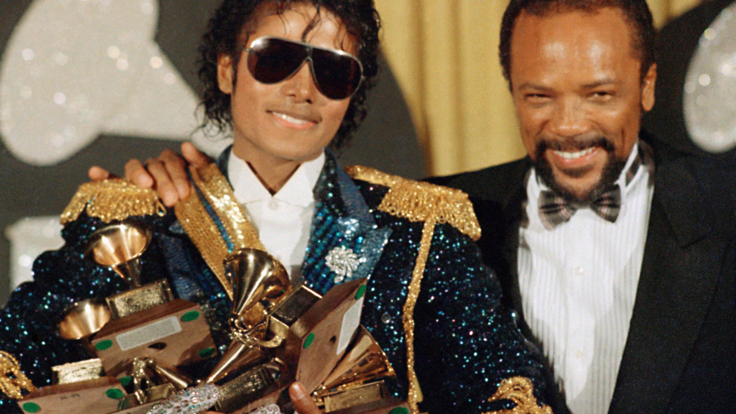 FILE - Michael Jackson, left, holds eight awards as he poses with Quincy Jones at the Grammy Awards in Los Angeles, Feb. 28, 1984. Quincy Jones died at age 91. (AP Photo/Doug Pizac, File)