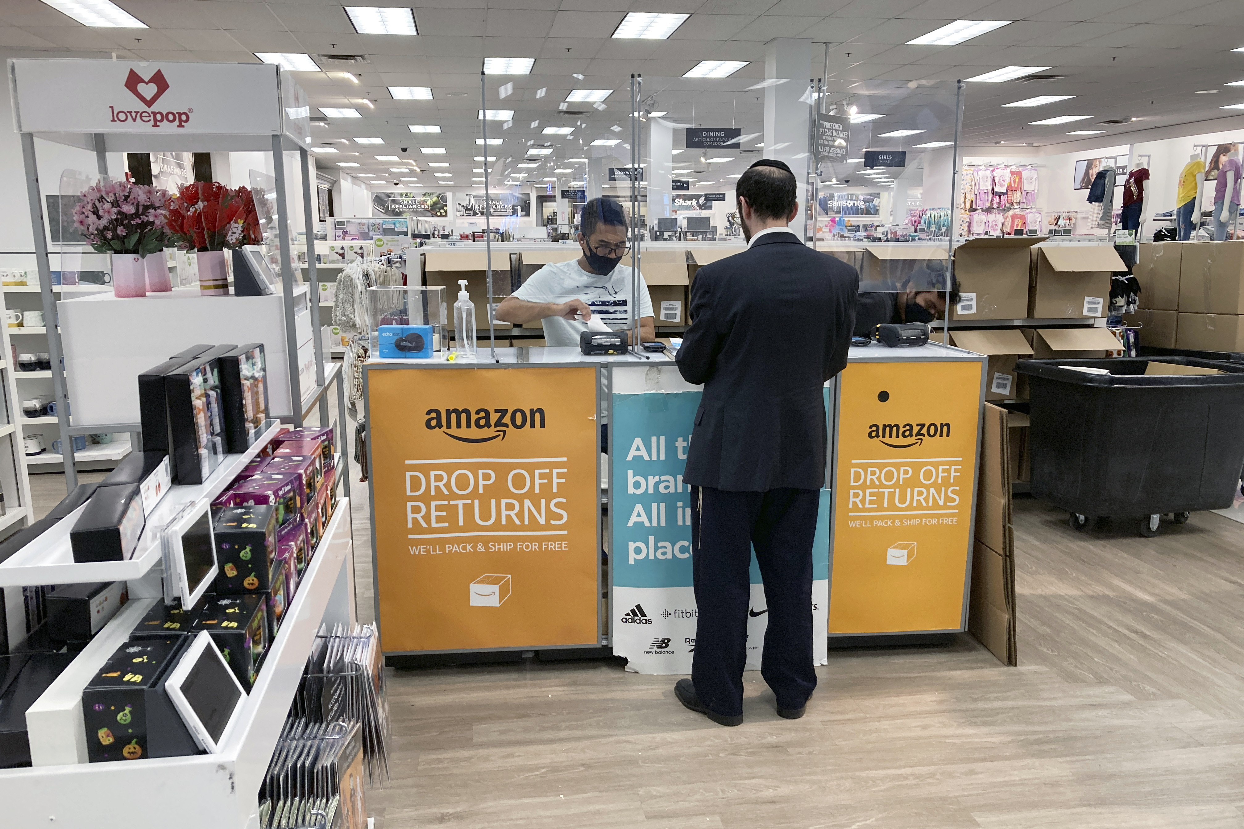 FILE - People return items purchased online at an Amazon counter inside a Kohl's department store in Clifton, New Jersey, on September 3, 2021. (AP Photo/Ted Shaffrey, File)