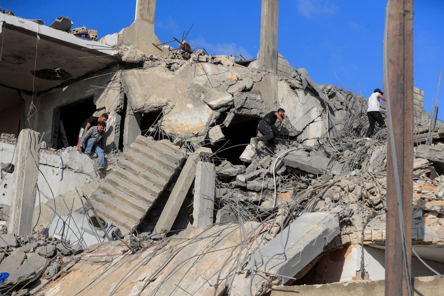 People search for victims at a destroyed building hit in an Israeli airstrike, in Ghaziyeh town, south Lebanon, Sunday, Nov. 3, 2024. (AP Photo/Mohammed Zaatari)