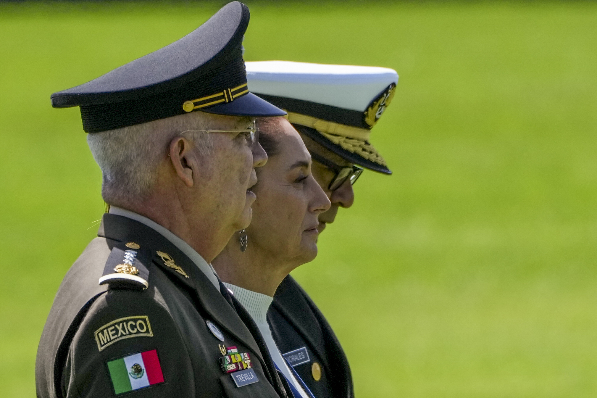 FILE - Mexican President Claudia Sheinbaum, center, reviews the troops with Defense Minister Gen. Ricardo Trevilla Trejo, left, and Navy Secretary Alt. Raymundo Pedro Morales, at Campo Marte in Mexico City, Oct. 3, 2024. (AP Photo/Fernando Llano, File)