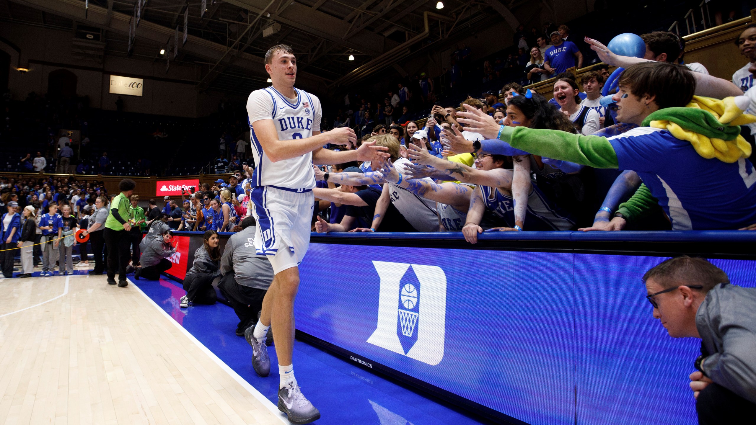 Duke's Cooper Flagg (2) high-fives fans after an NCAA college basketball game against Maine in Durham, N.C., Monday, Nov. 4, 2024. (AP Photo/Ben McKeown)