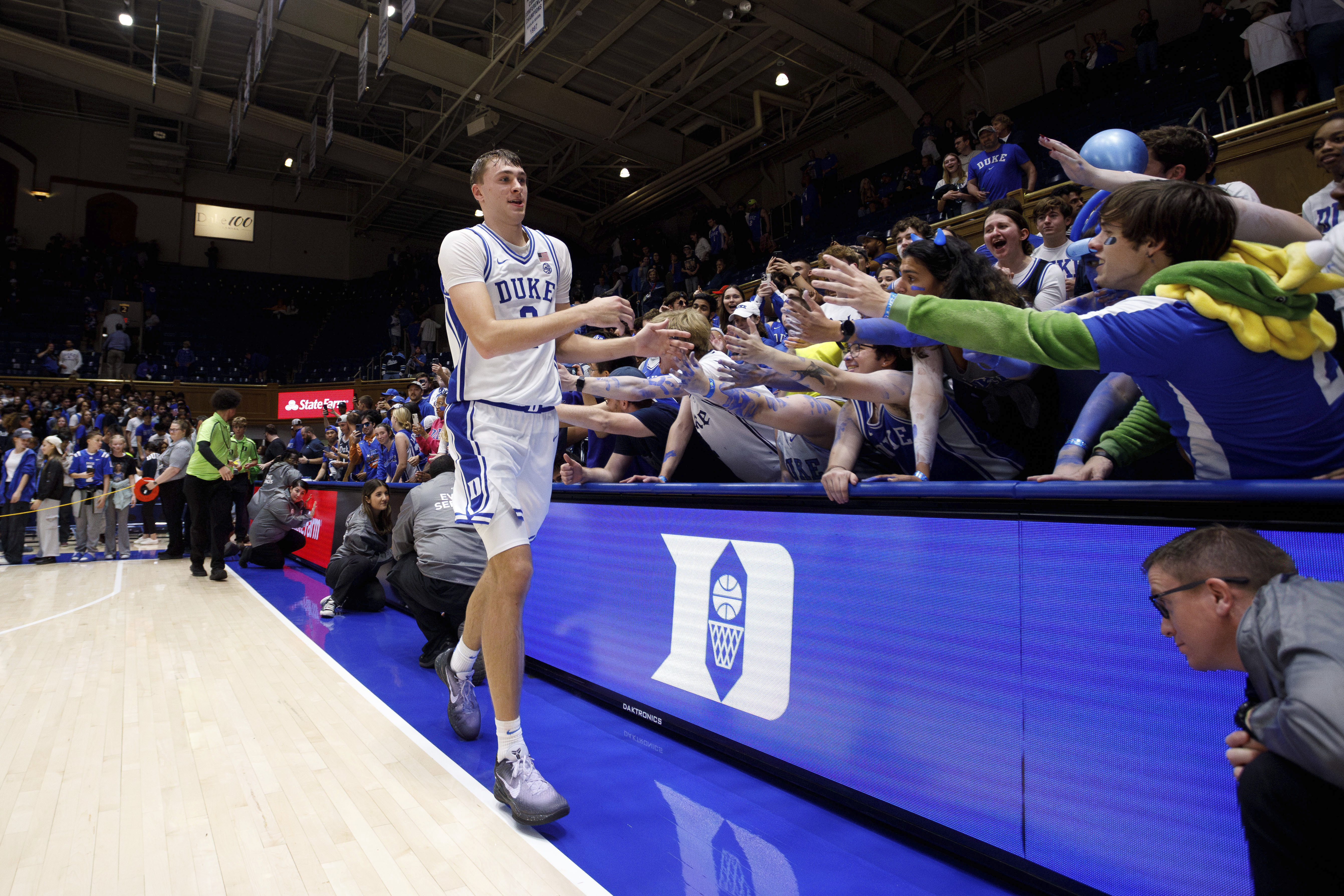 Duke's Cooper Flagg (2) high-fives fans after an NCAA college basketball game against Maine in Durham, N.C., Monday, Nov. 4, 2024. (AP Photo/Ben McKeown)