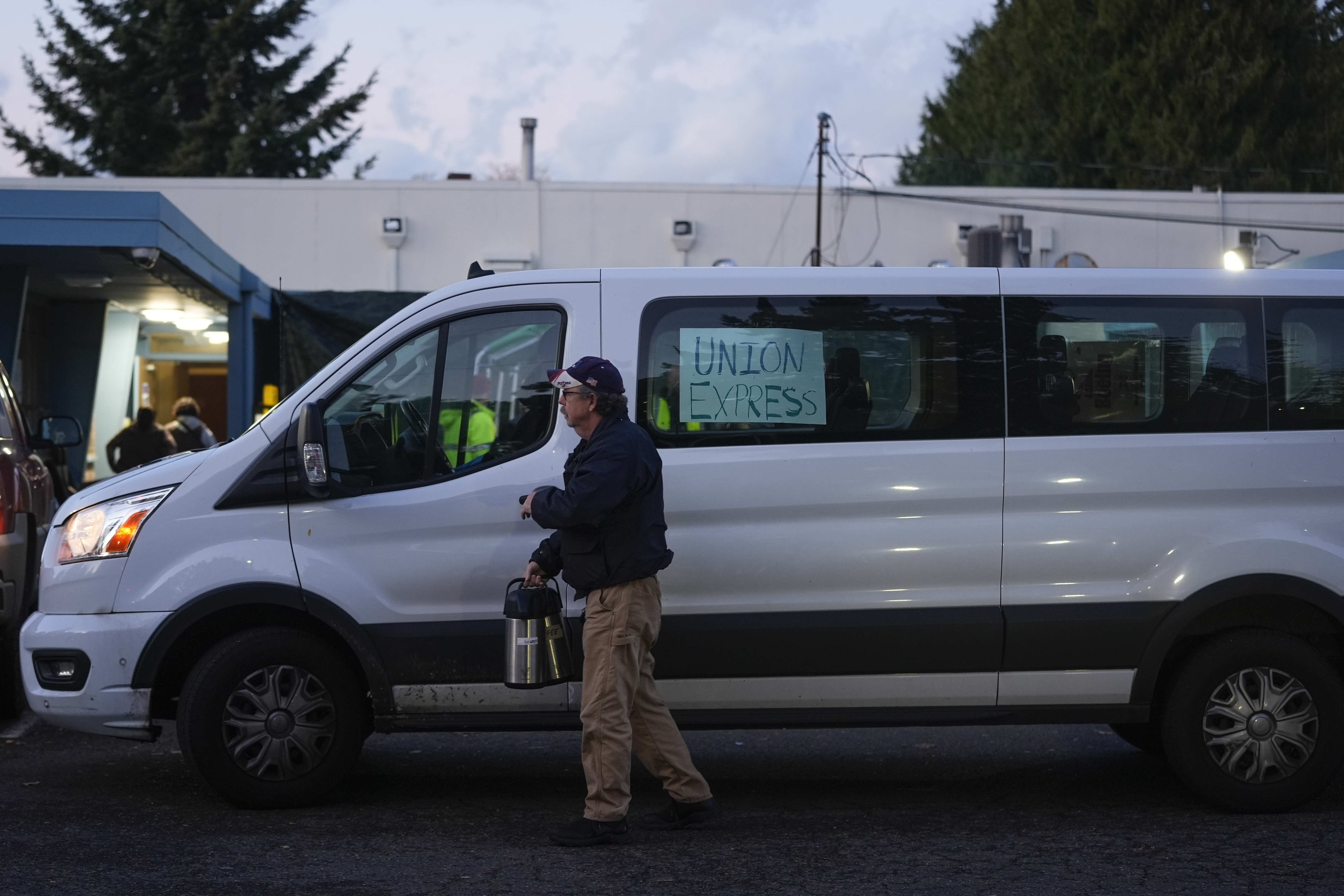 A Boeing employee driving a "union express" van carries carafes as workers vote on a new contract offer from the company Monday, Nov. 4, 2024, at the Aerospace Machinists Union hall in Renton, Wash. (AP Photo/Lindsey Wasson)