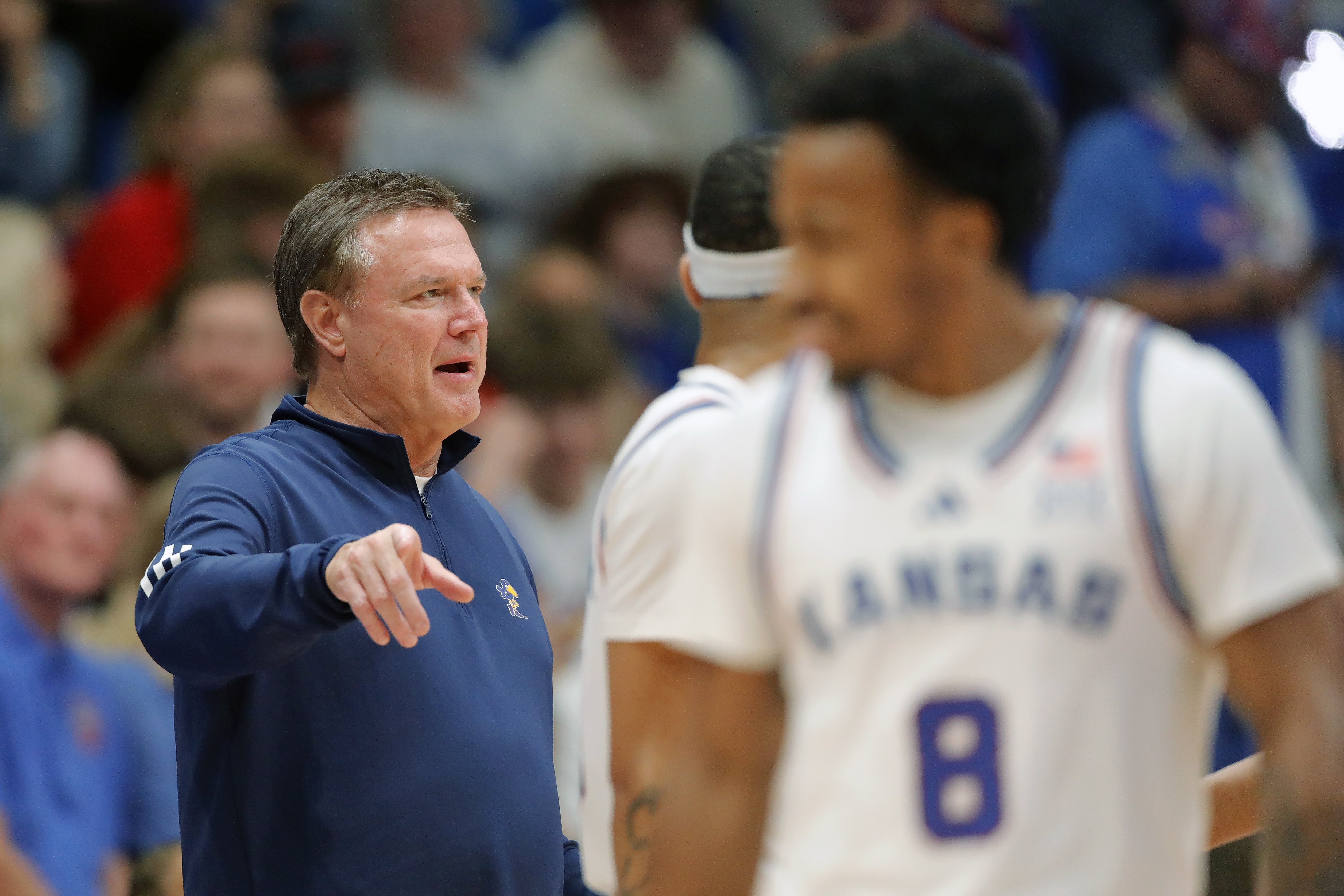 Kansas head coach Bill Self, left, speaks with his players during the second half of an NCAA college basketball game against Howard, Monday, Nov. 4, 2024, in Lawrence, Kan. (AP Photo/Colin E. Braley)