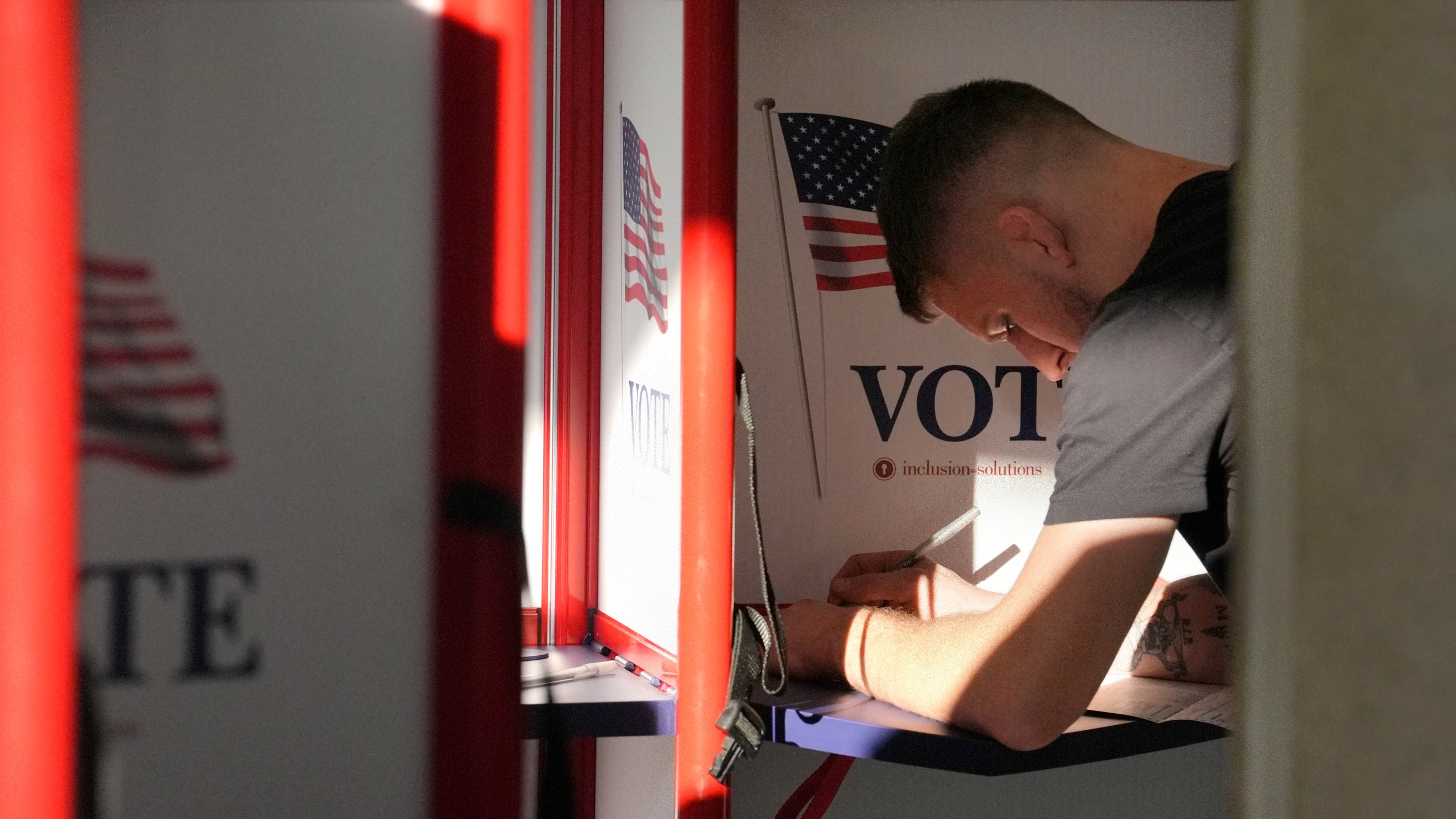 A voter fills out their their ballot during early voting in the general election, Friday, Nov. 1, 2024, in Fall River, Mass. (AP Photo/Steven Senne)