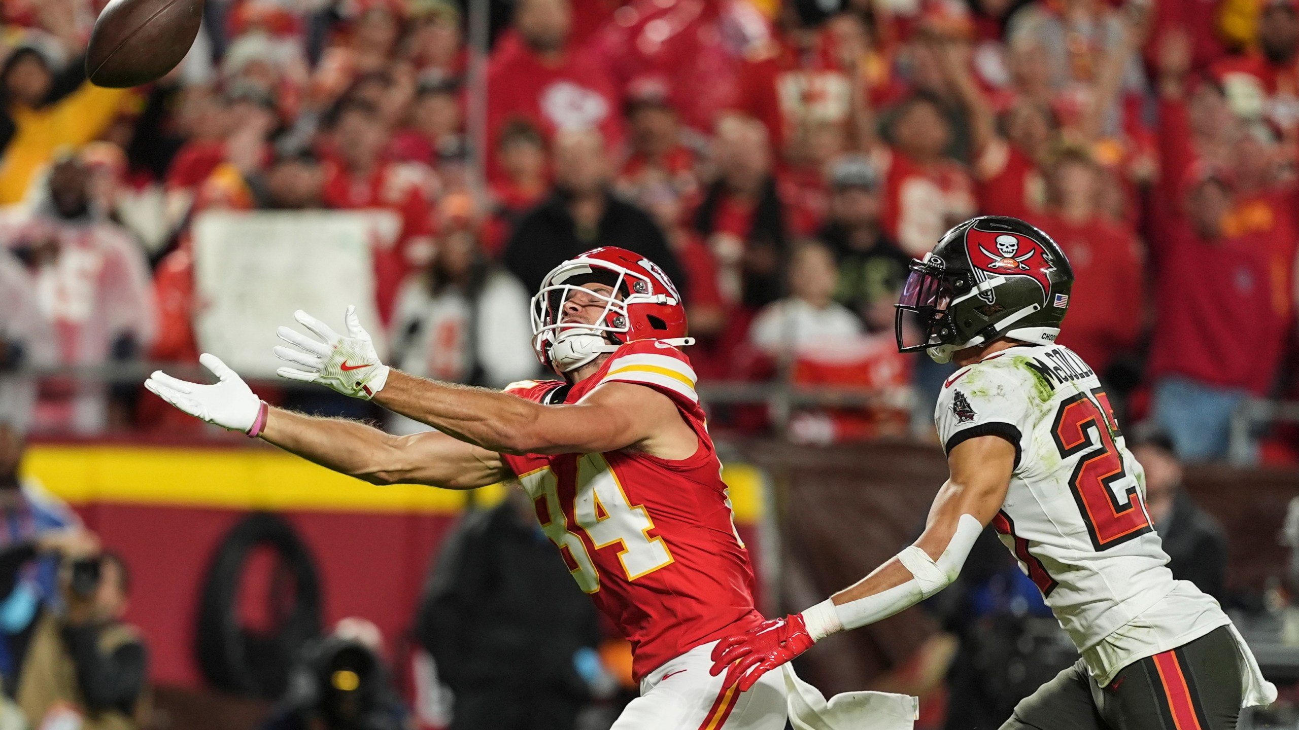 Kansas City Chiefs wide receiver Justin Watson (84) works for a catch against Tampa Bay Buccaneers cornerback Zyon McCollum (27) during the first half of an NFL football game, Monday, Nov. 4, 2024, in Kansas City, Mo. (AP Photo/Charlie Riedel)