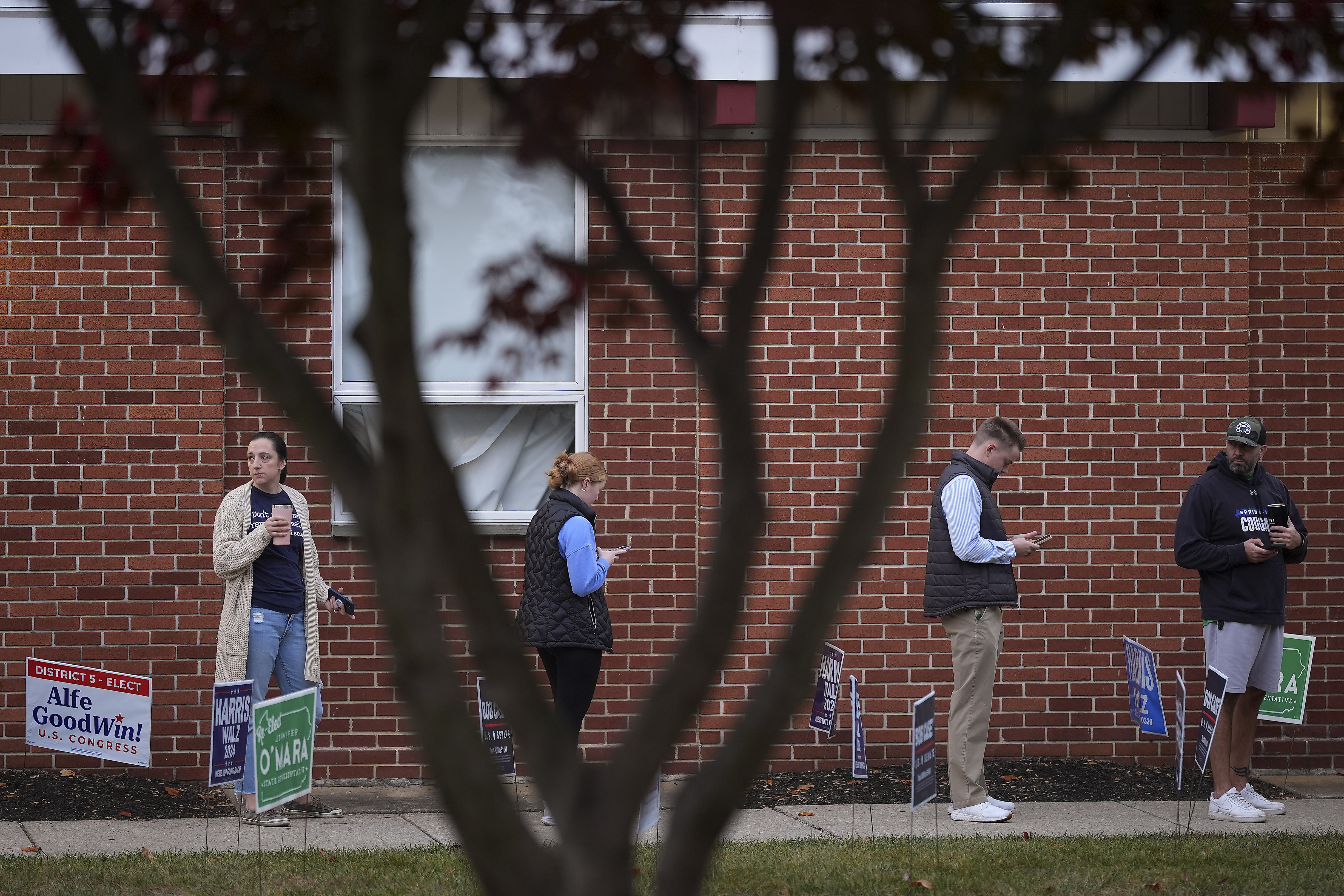 Voters stand in line while waiting for a polling place to open, Tuesday, Nov. 5, 2024, in Springfield, Pa. (AP Photo/Matt Slocum)