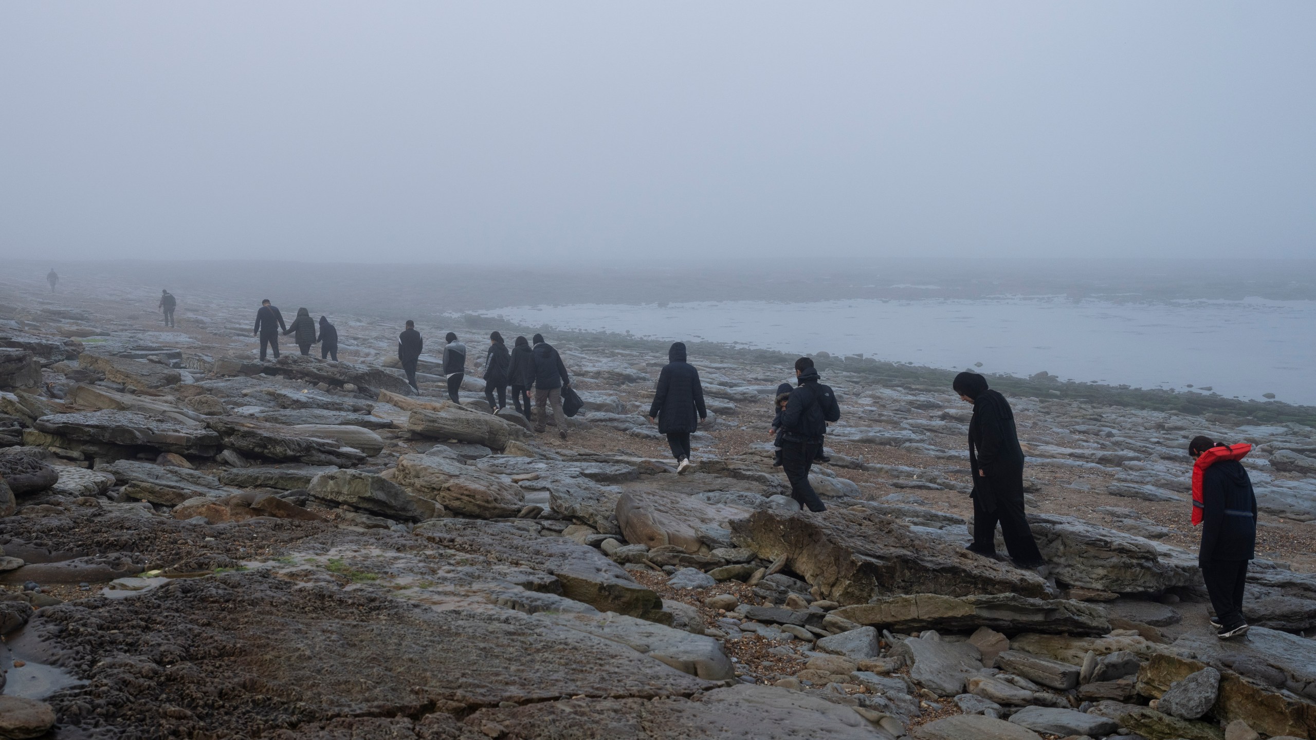 FILE - A group of Kurdish migrants from Iran and Iraq who failed in their attempt to reach the United Kingdom by boat walk back to the town of Ambleteuse, northern France, on Sunday, May 19, 2024, after being discovered by the police. (AP Photo/Bernat Armangue, File)