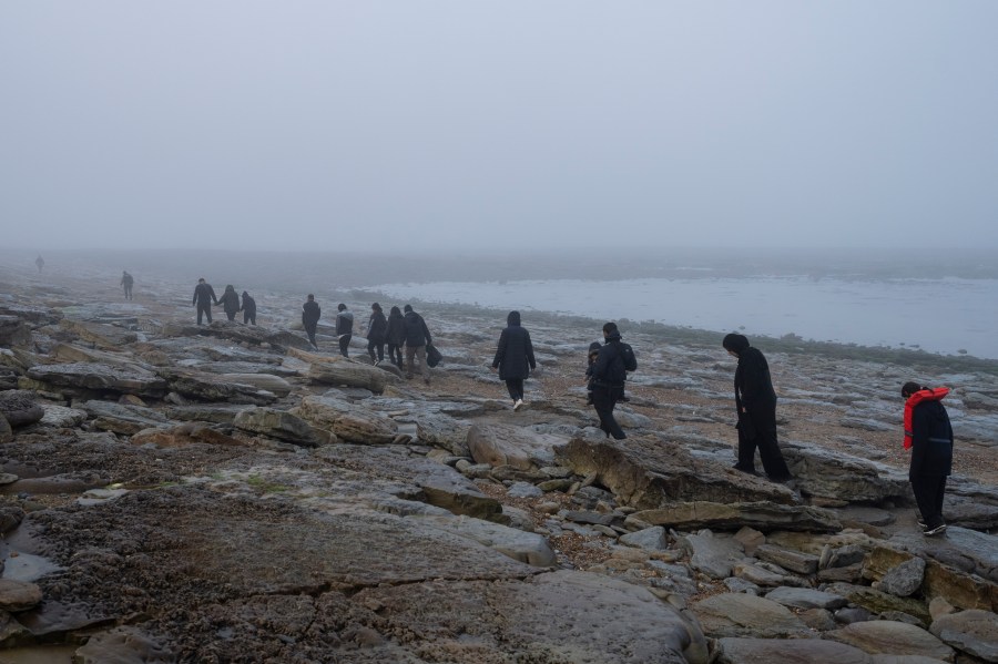 FILE - A group of Kurdish migrants from Iran and Iraq who failed in their attempt to reach the United Kingdom by boat walk back to the town of Ambleteuse, northern France, on Sunday, May 19, 2024, after being discovered by the police. (AP Photo/Bernat Armangue, File)