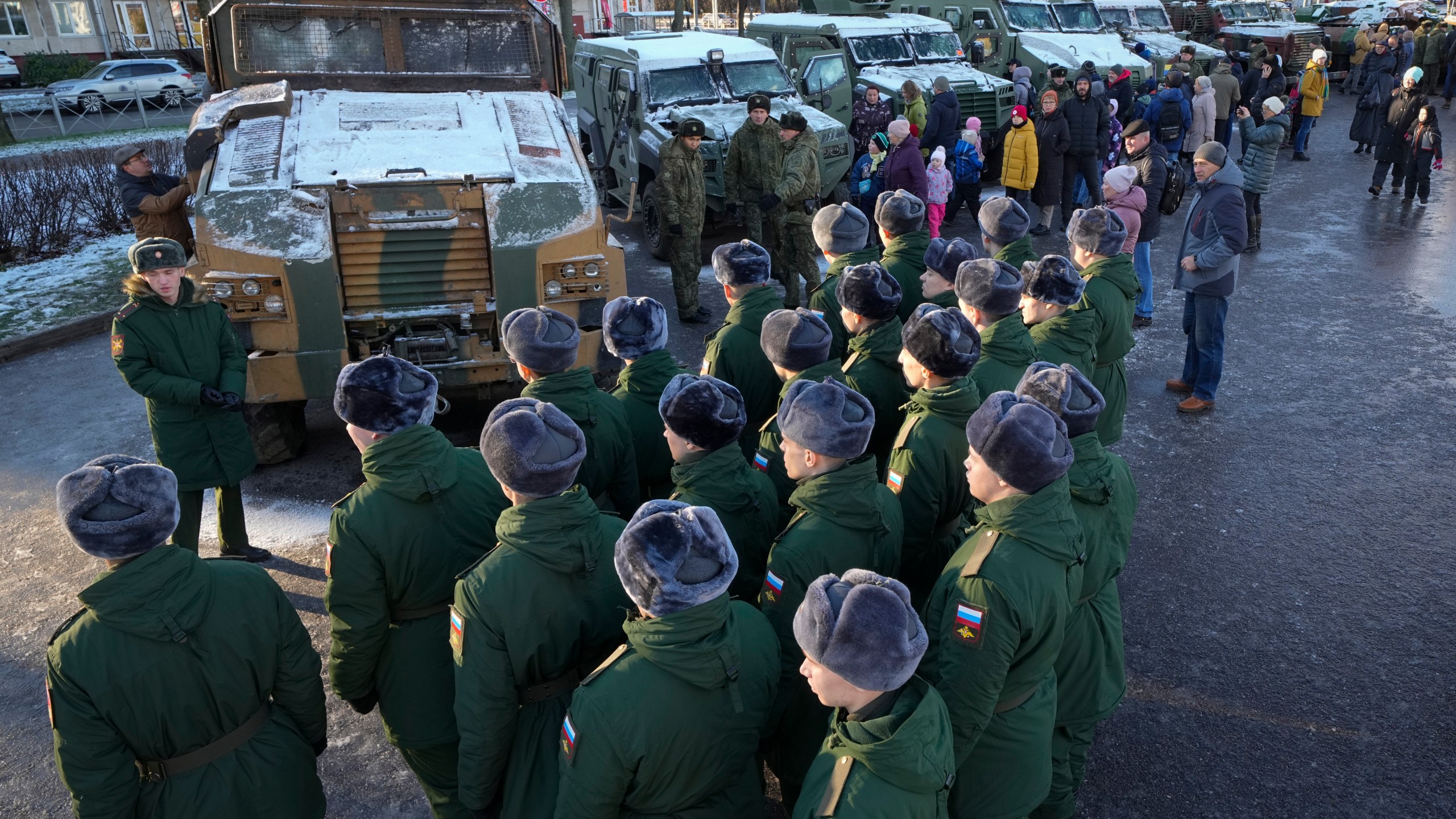 Russian servicemen examine Ukrainian military vehicles at an exhibition featuring military equipment captured from Kyiv forces during the fighting in Ukraine, during Russia's National Unity Day in St. Petersburg, Russia, Monday, Nov. 4, 2024. (AP Photo/Dmitri Lovetsky)