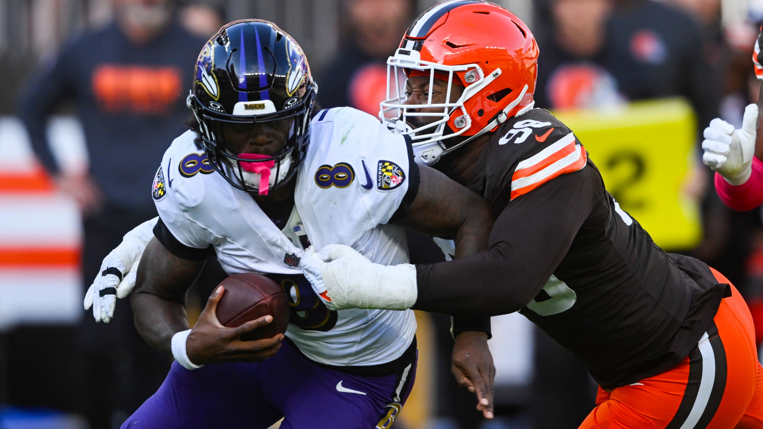 Cleveland Browns defensive end Za'Darius Smith (99) sacks Baltimore Ravens quarterback Lamar Jackson (8) during the second half of an NFL football game in Cleveland, Sunday, Oct. 27, 2024. (AP Photo/David Richard)