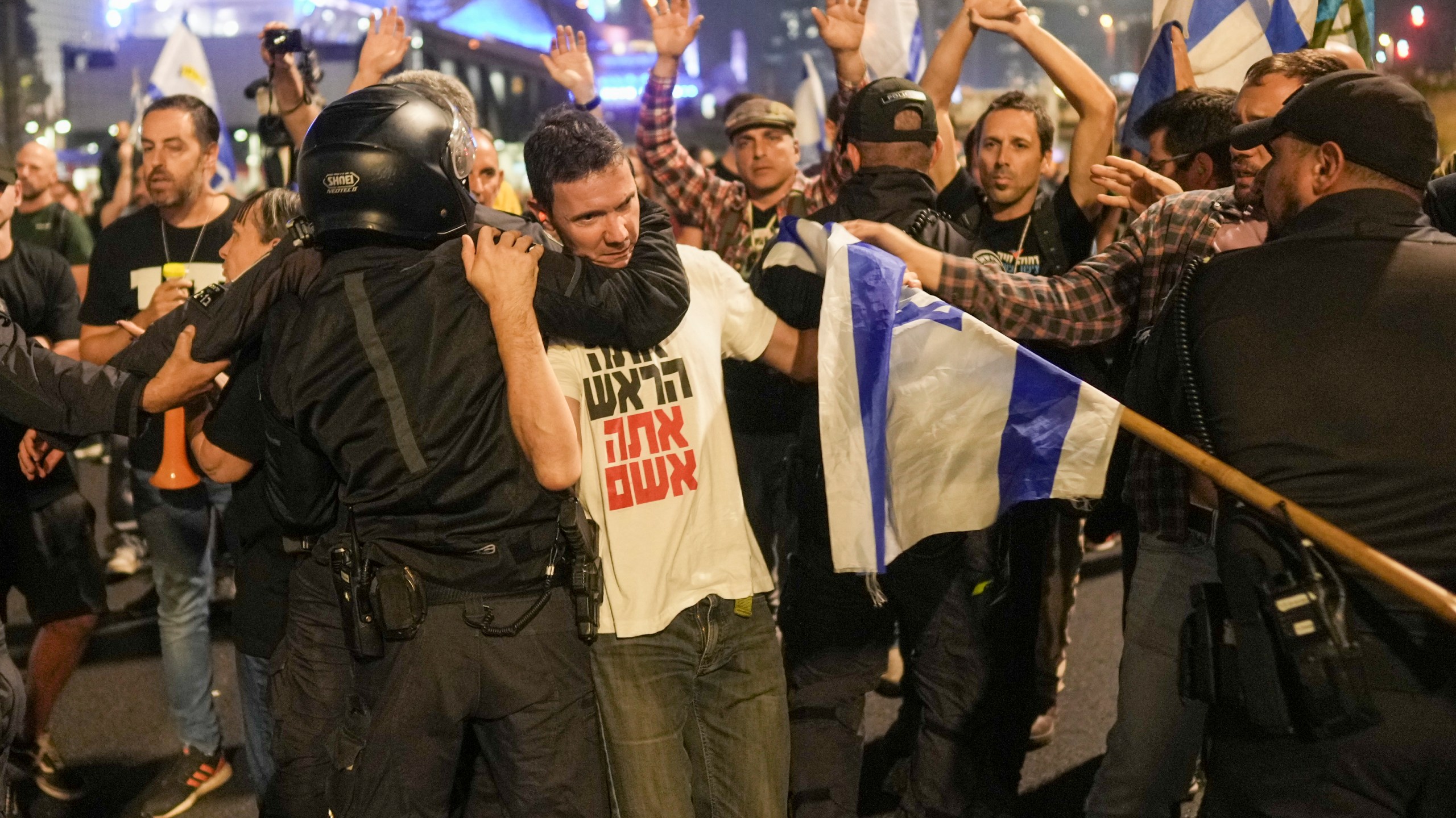 Israeli police try to push back protesters from a main road after Prime Minister Benjamin Netanyahu has dismissed his defense minister Yoav Gallant in a surprise announcement in Tel Aviv, Israel, Tuesday, Nov. 5, 2024. (AP Photo/Oded Balilty)