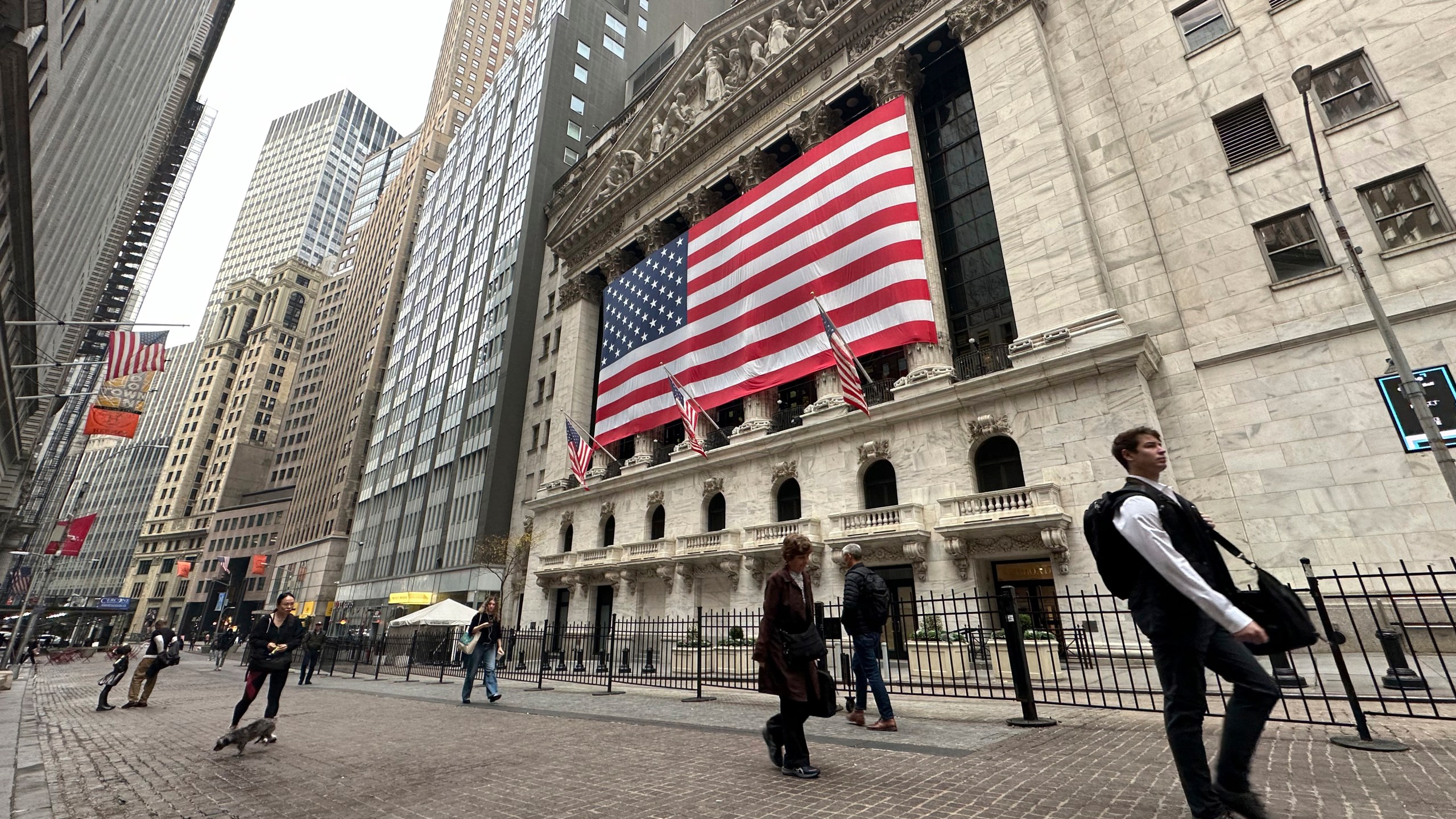 People pass the New York Stock Exchange in New York's Financial District on Tuesday, Nov. 5, 2024. (AP Photo/Peter Morgan)