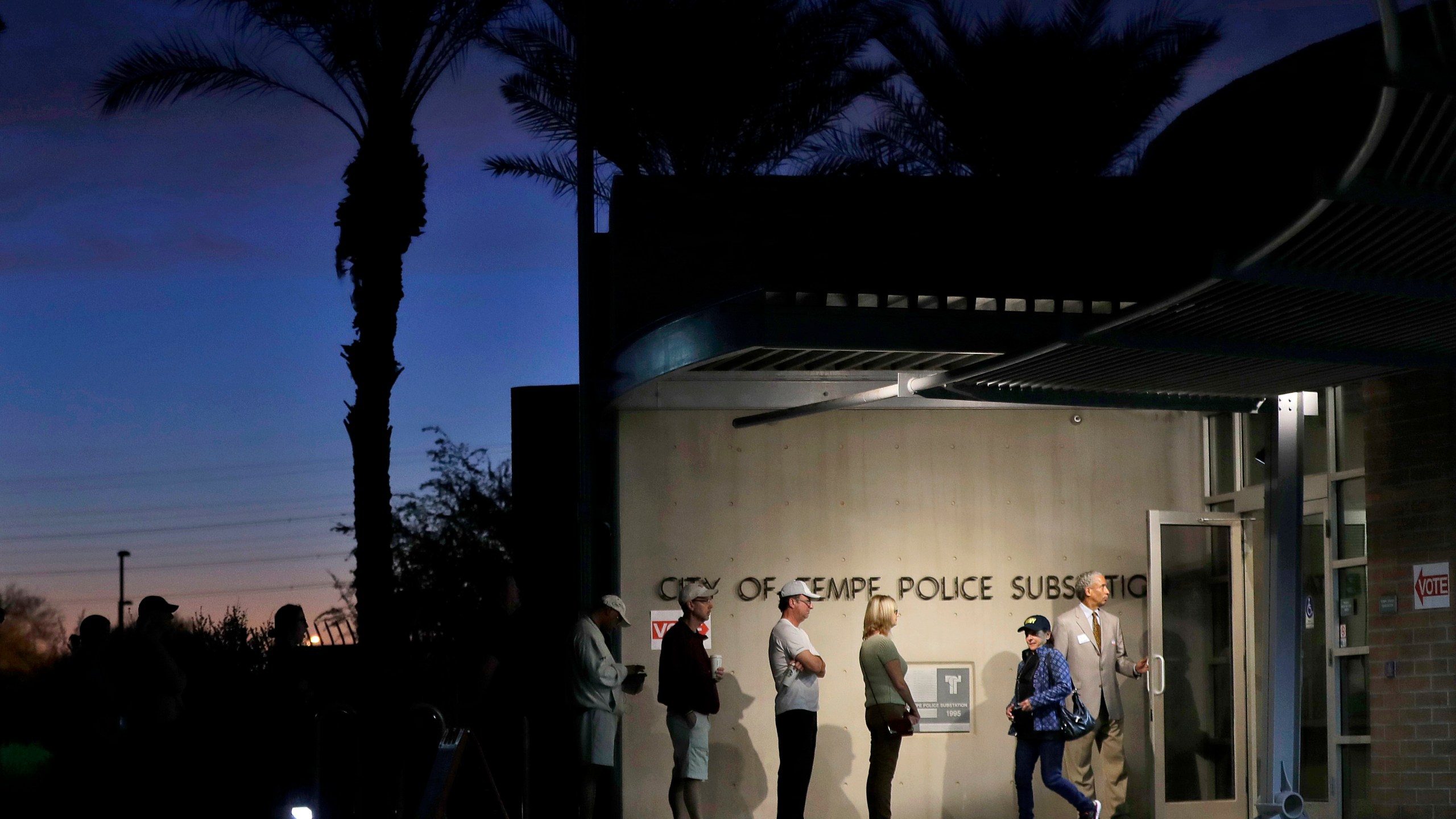 FILE - Voters wait in line to vote at their polling station early, Tuesday, Nov. 8, 2016, in Tempe, Ariz. (AP Photo/Matt York, File)